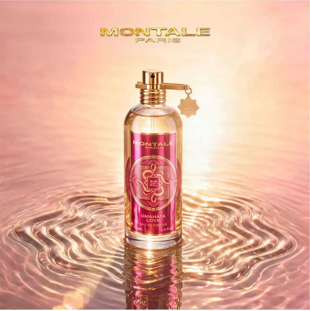 Perfume bottle standing in rippling golden water under a soft pink sunset glow, Montale Paris logo above