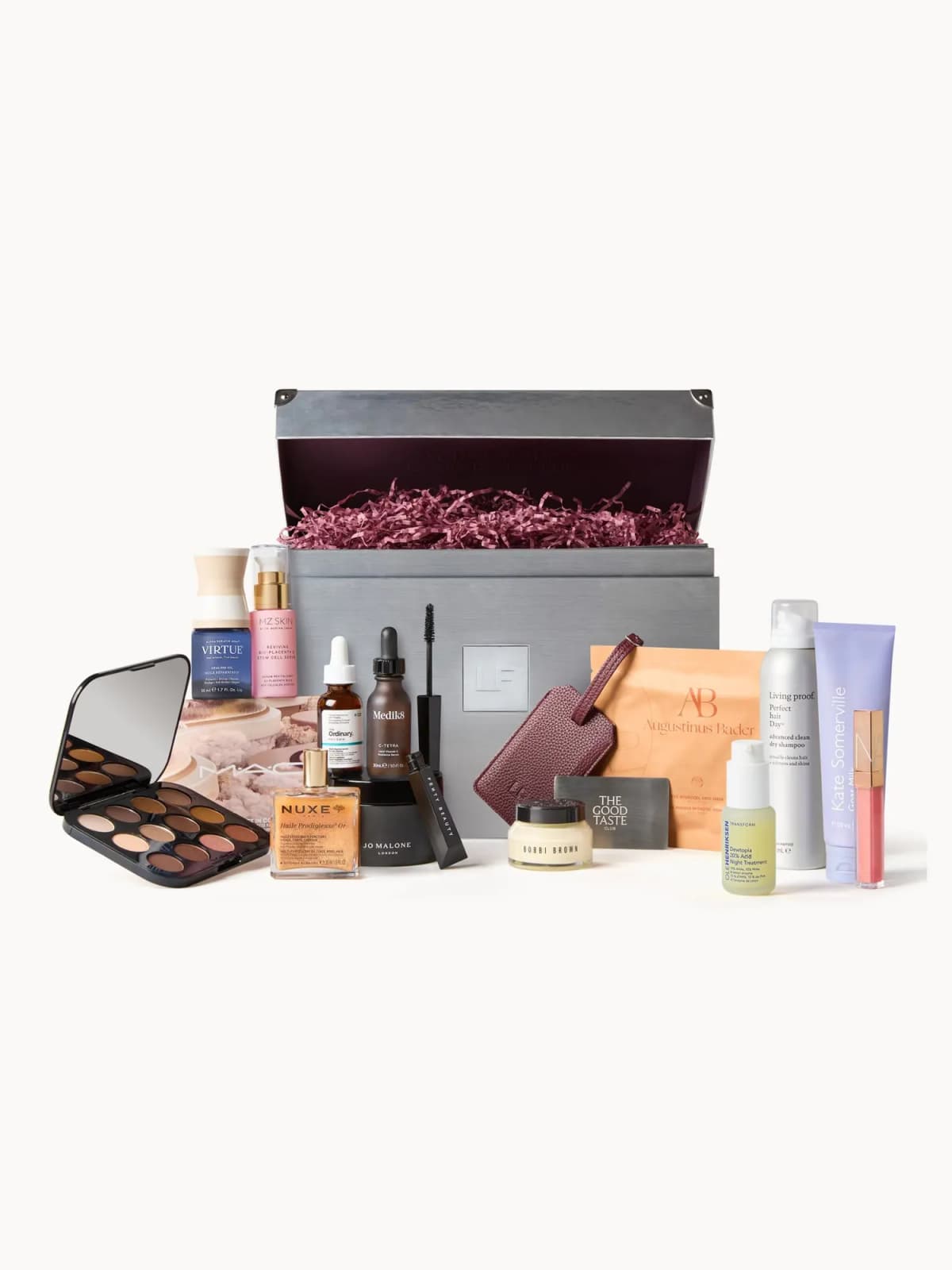 Silver LF trunk with burgundy lining and all products arranged in front, including an open MAC eyeshadow palette