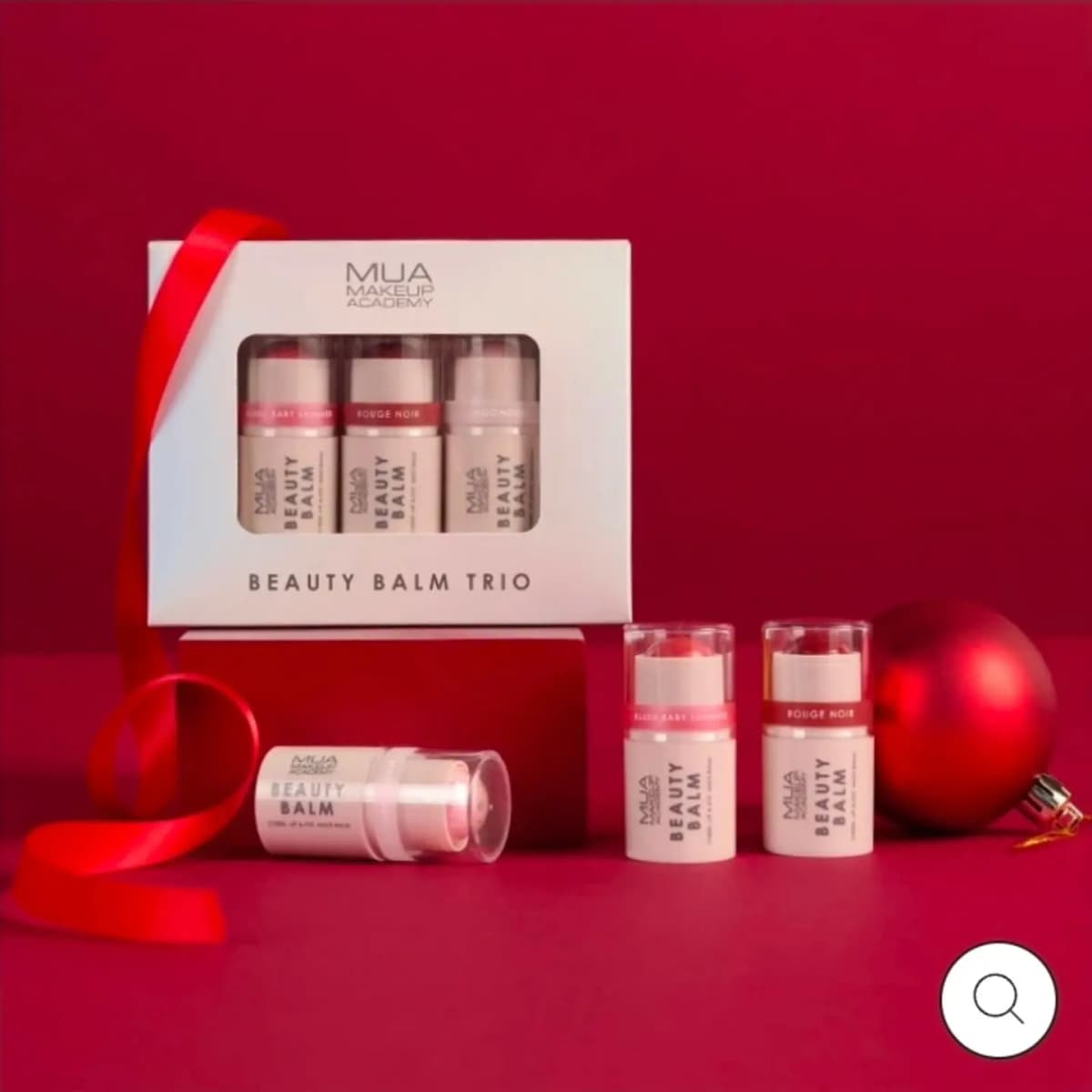 MUA Beauty Balm Trio box with Blush Baby Shimmer, Rouge Noir and a pink balm stick beside a red bauble and ribbon.