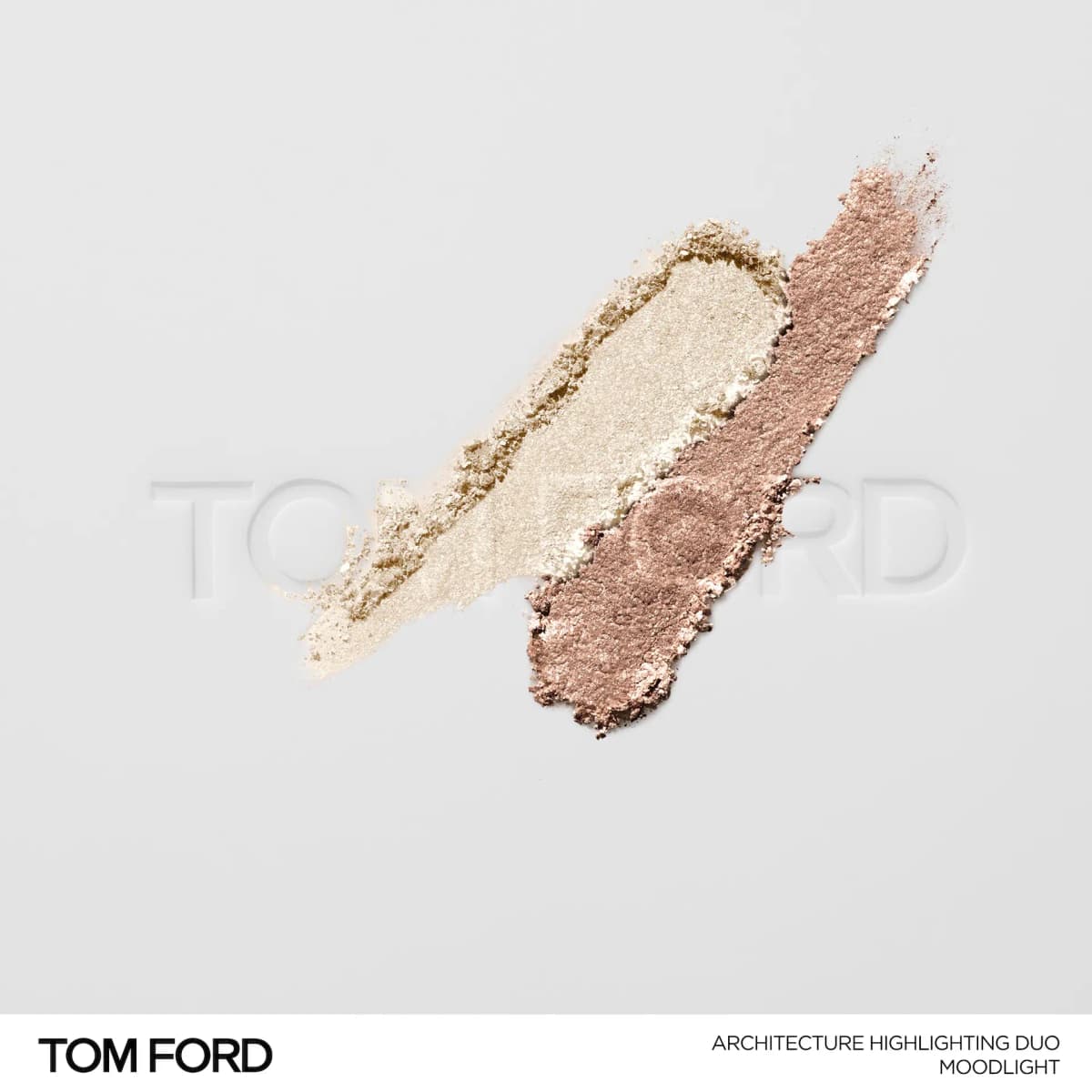 Crushed Moodlight swatches of ivory and muted rosy-taupe shimmer powder on a white Tom Ford embossed surface.