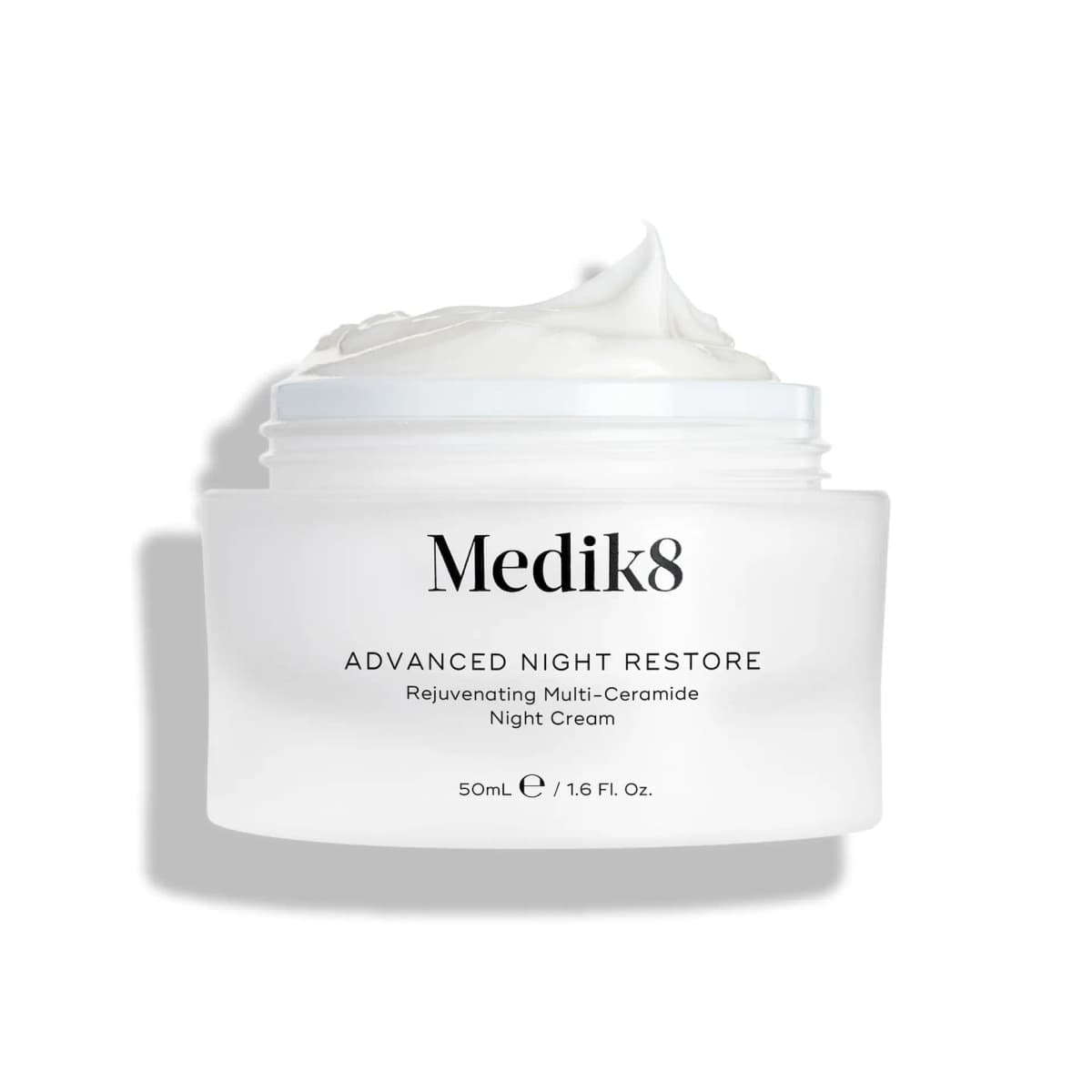 Medik8 Advanced Night Restore night cream in an open white jar topped with a swirl of cream