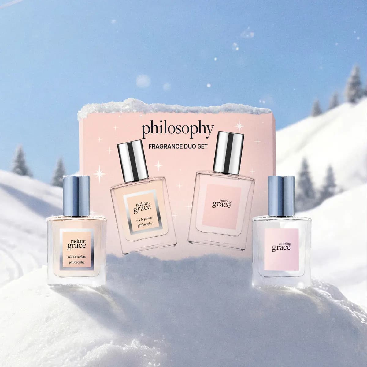 Philosophy Fragrance Duo Set box with radiant grace and amazing grace perfume bottles on a snowy mountain hill