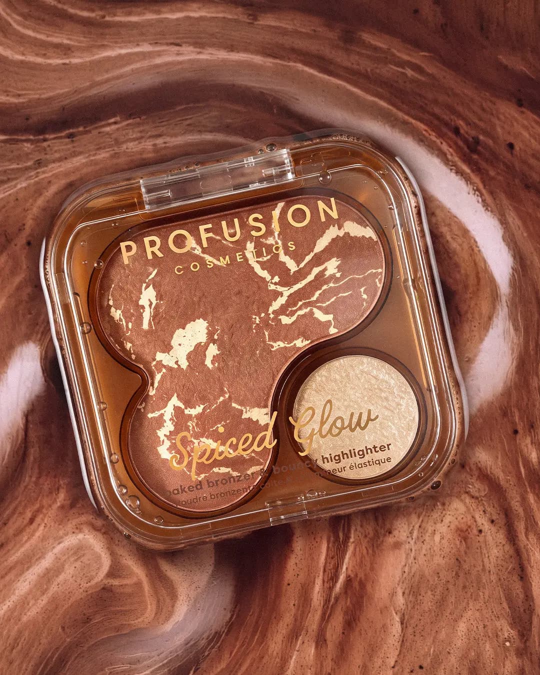 Spiced Glow bronzer and highlighter compact resting on swirled brown coffee and cream liquid.