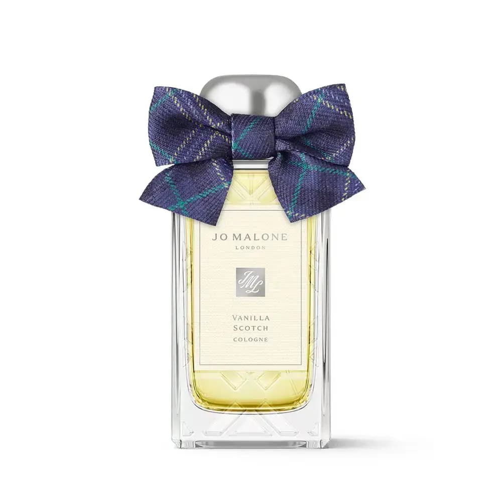 Vanilla Scotch bottle in etched cut-glass design topped with a purple and teal tartan bow
