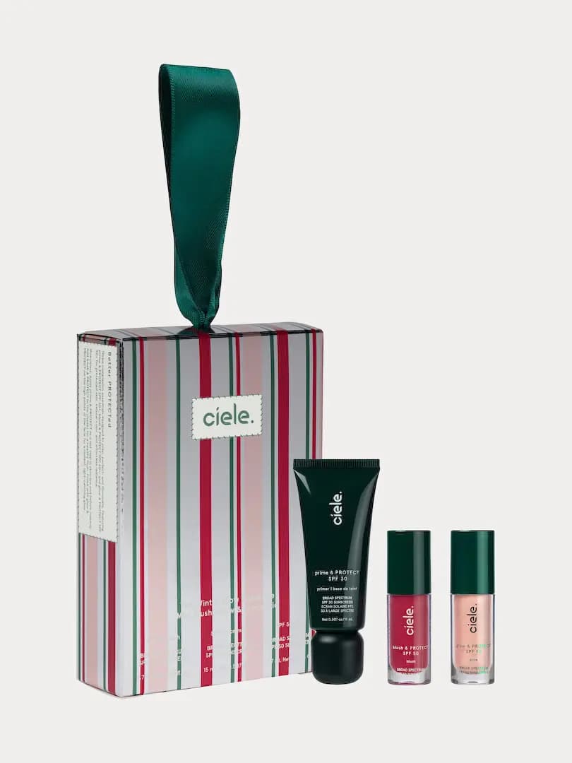 Ciele The Winter Wardrobe complexion trio: striped ornament box with green ribbon, primer tube, blush and glow minis