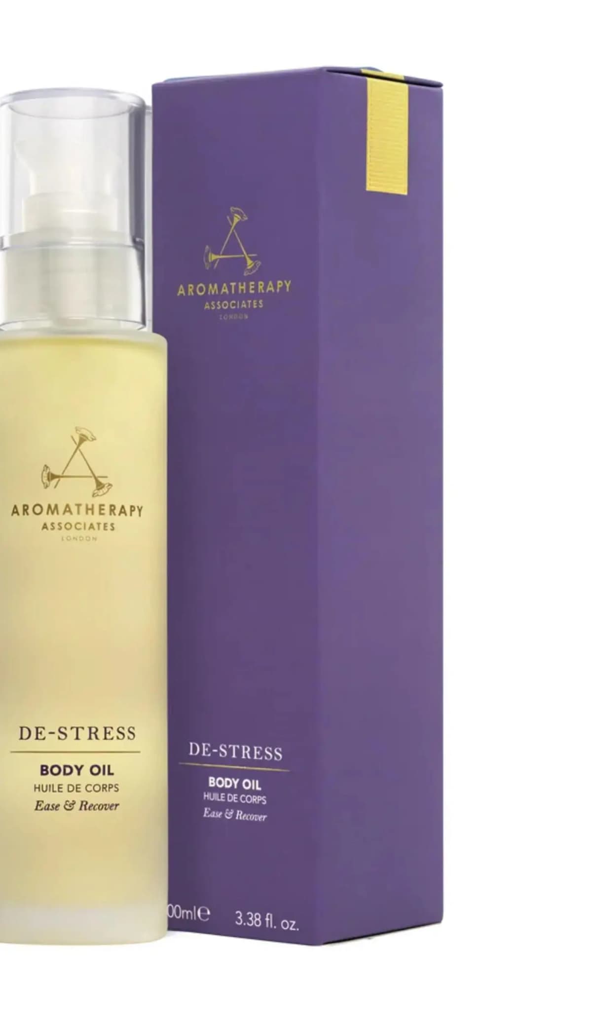 Aromatherapy Associates De-Stress Body Oil in a frosted yellow pump bottle beside its purple carton with gold logo