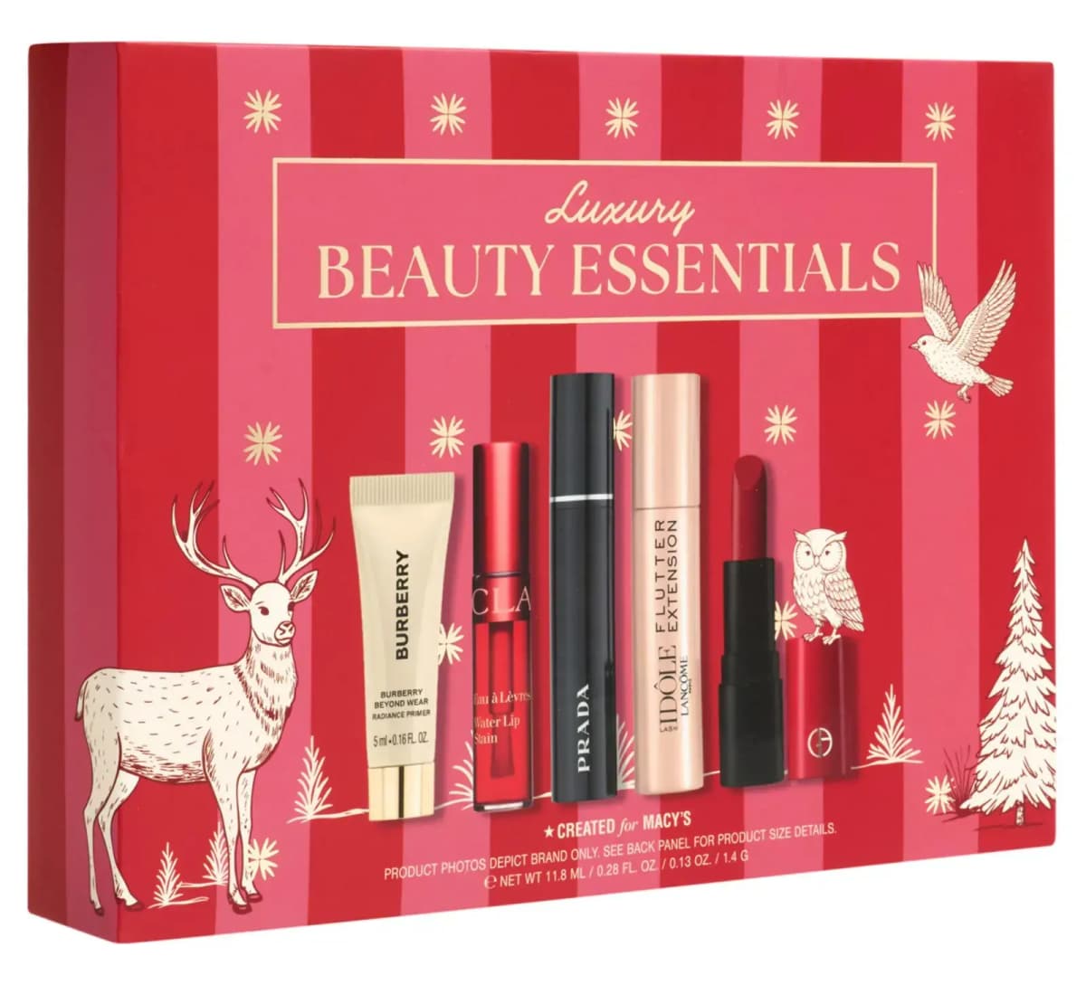Angled front of the red and pink striped Macy's Luxury Beauty Essentials gift box with gold reindeer, dove and owl motifs