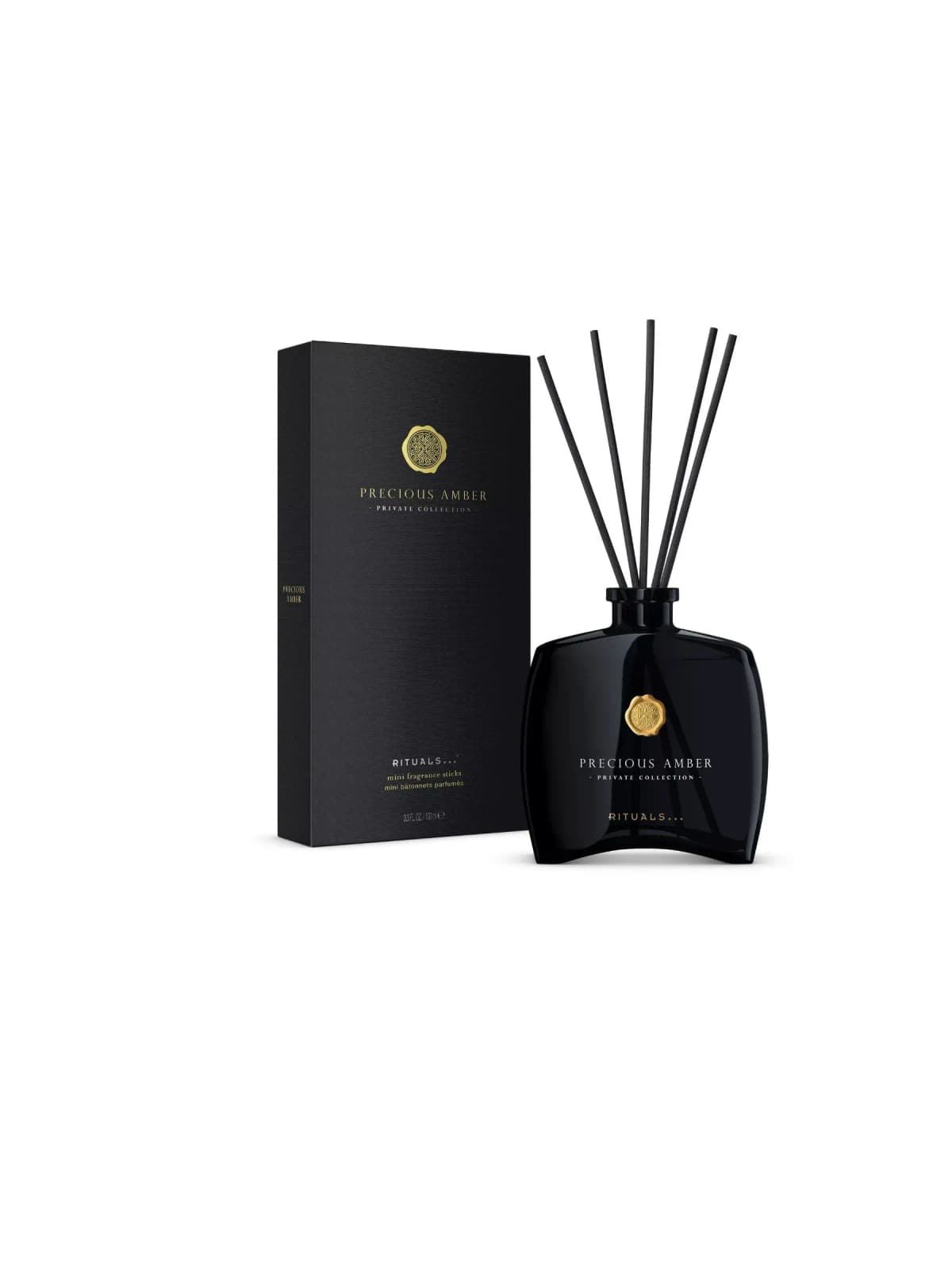 Black Rituals Precious Amber reed diffuser with five black sticks and gold seal beside its matching black box.