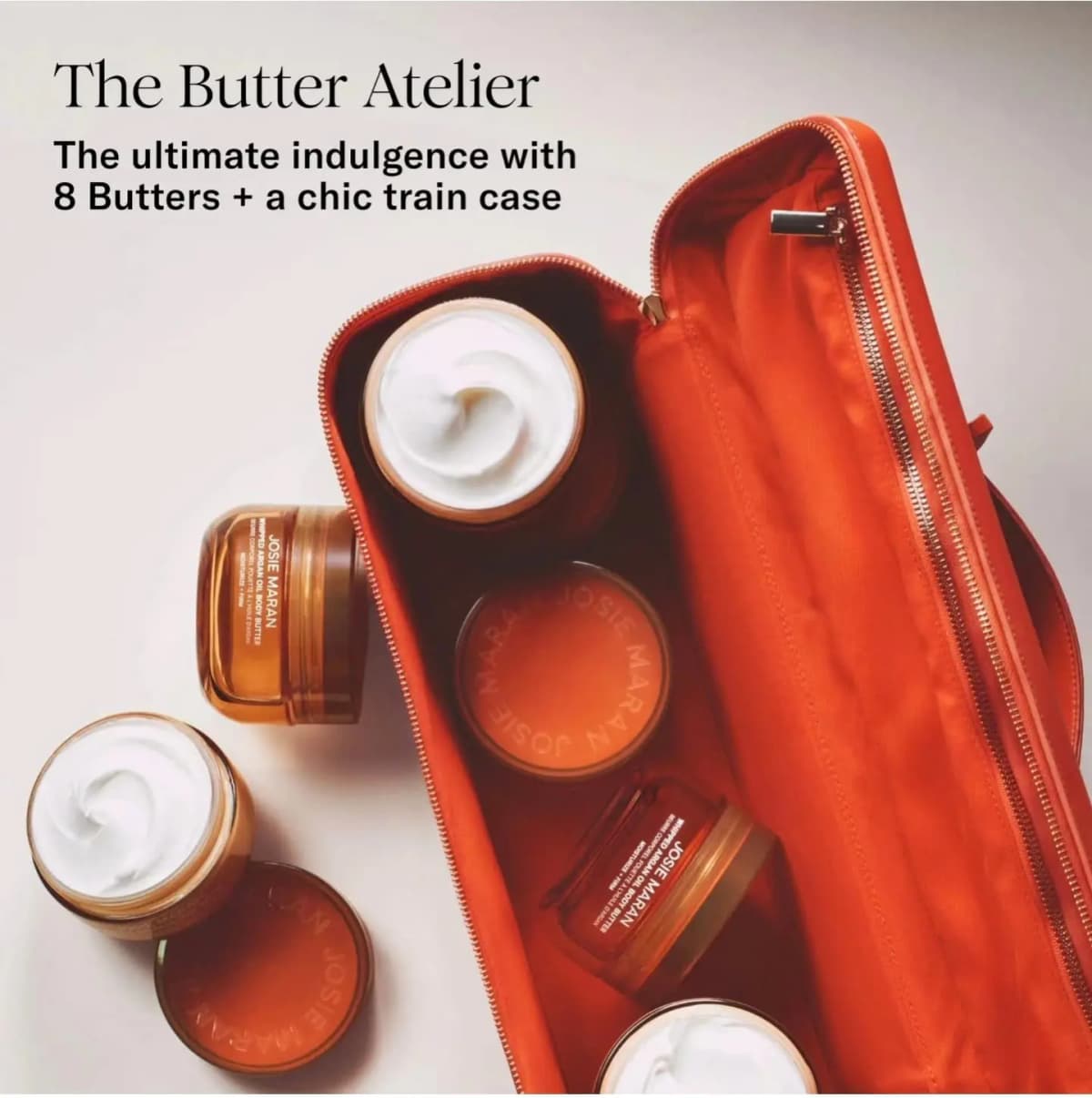 Open orange train case holding amber body butter jars, with text reading The Butter Atelier, 8 Butters + a chic train case