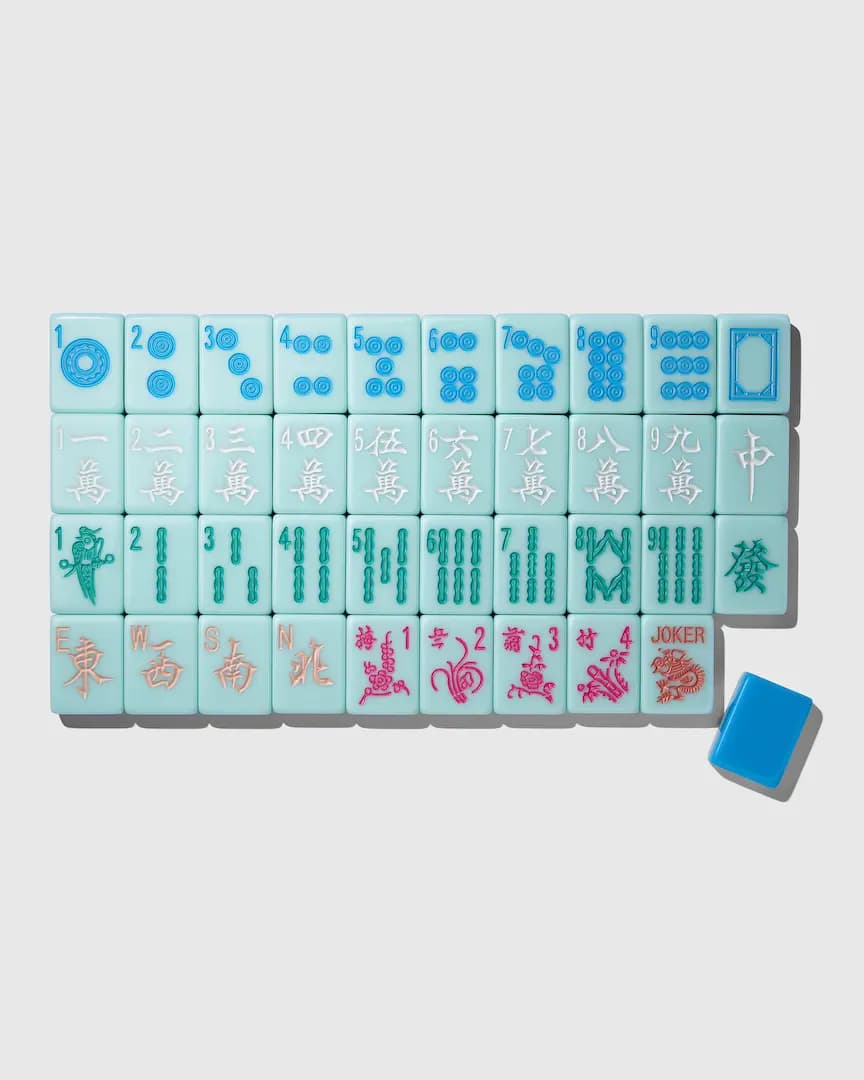 Westman Atelier The American Mahjong Tile Set laid out in rows: pale aqua tiles with blue dots, white characters, Joker