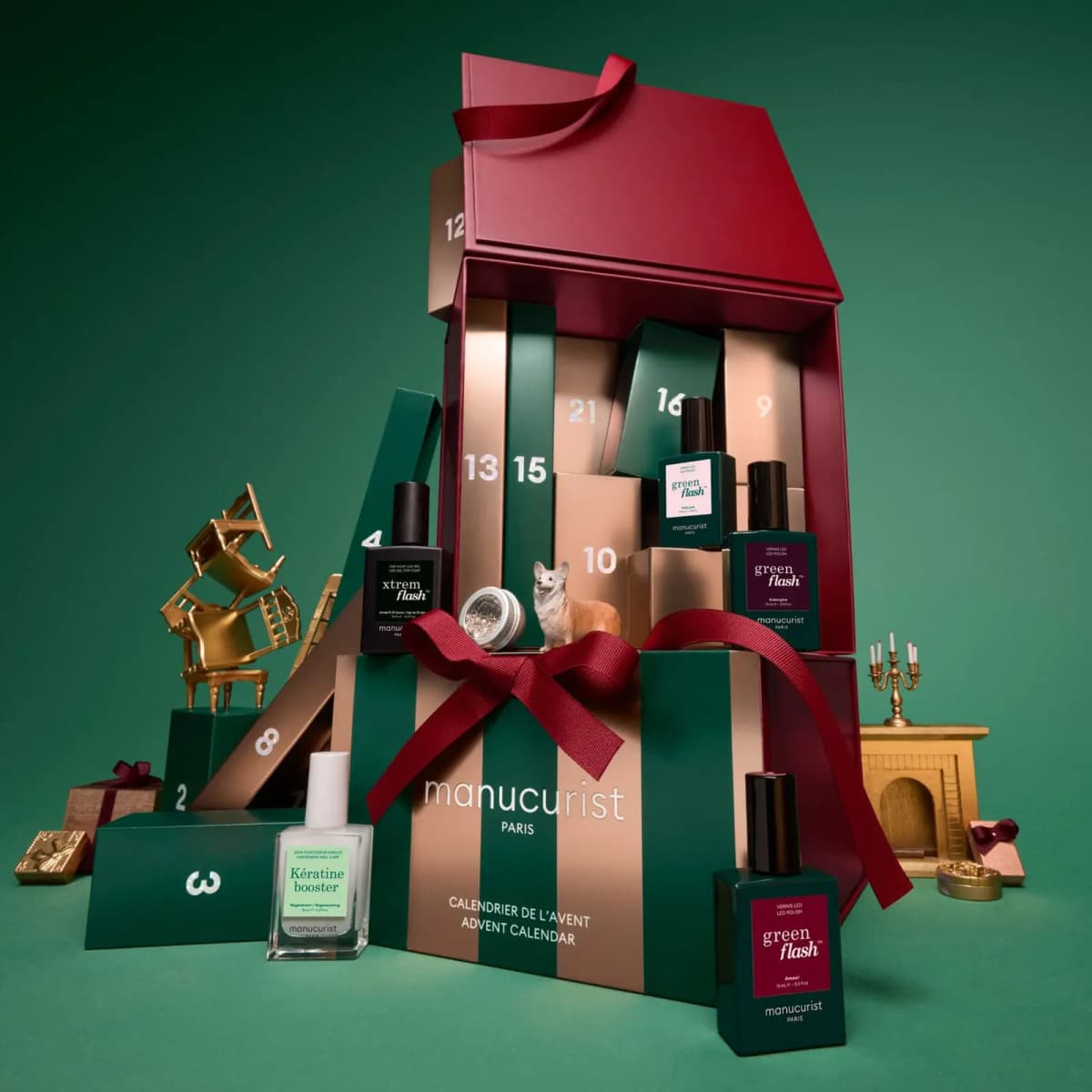 Green and gold striped advent calendar box with red ribbon, nail polish bottles