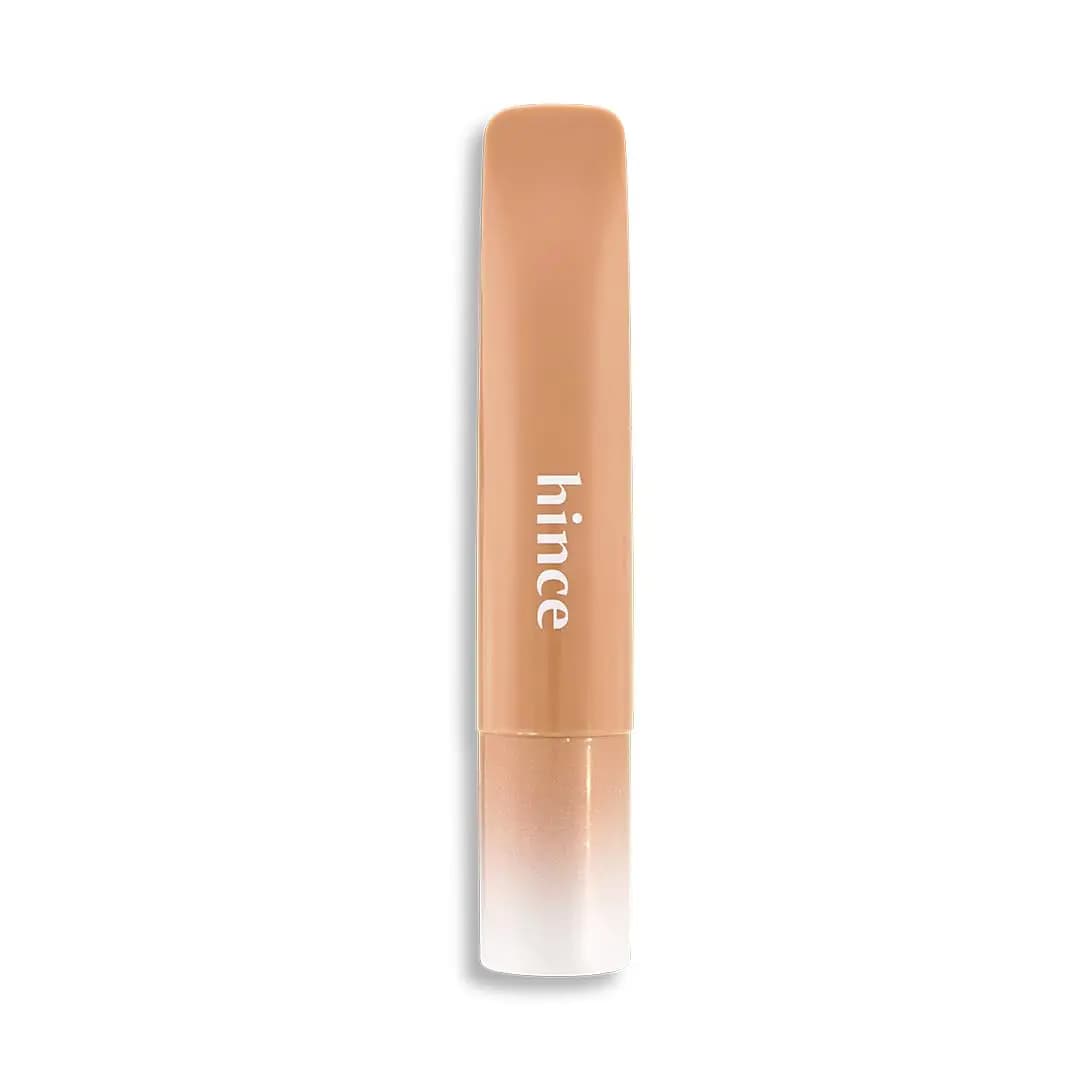 Warm caramel beige hince tube with white logo and shimmery tan gradient cap