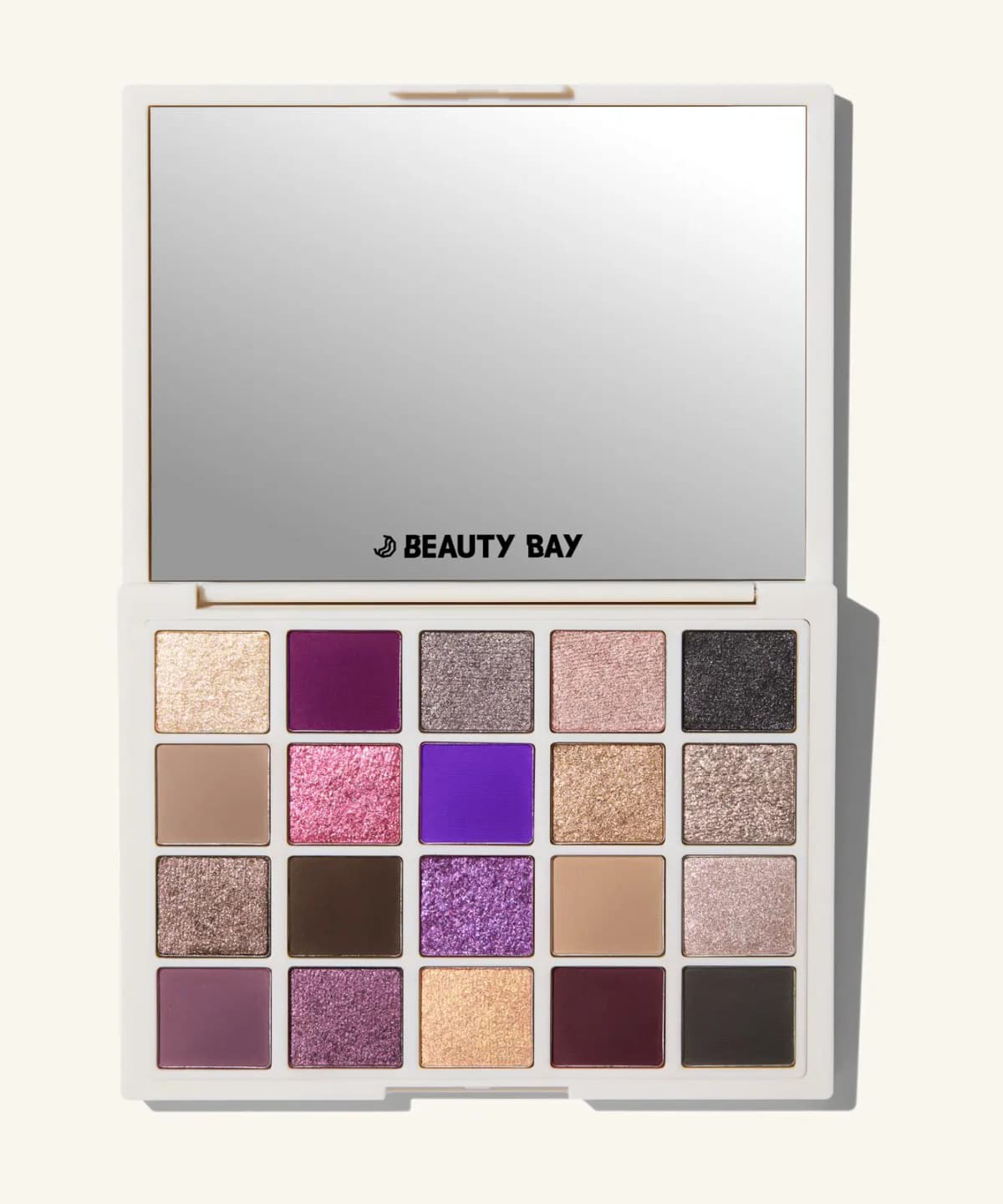 Open 20-pan eyeshadow palette in white case with mirror, showing gold, purple, pink, taupe and black shades