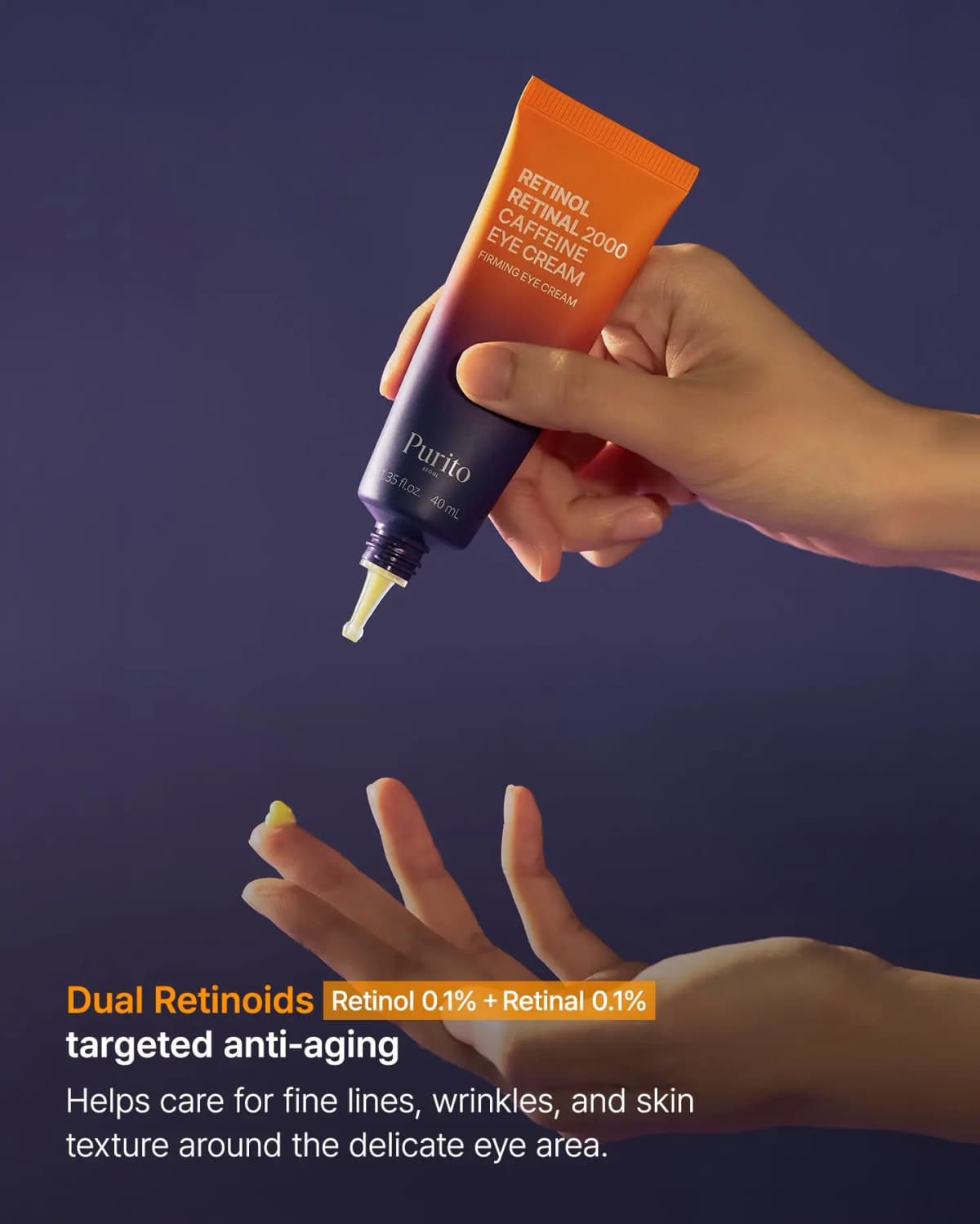 Hand squeezing a drop of pale yellow cream from the pointed nozzle of the Purito eye cream onto another hand's fingertip.