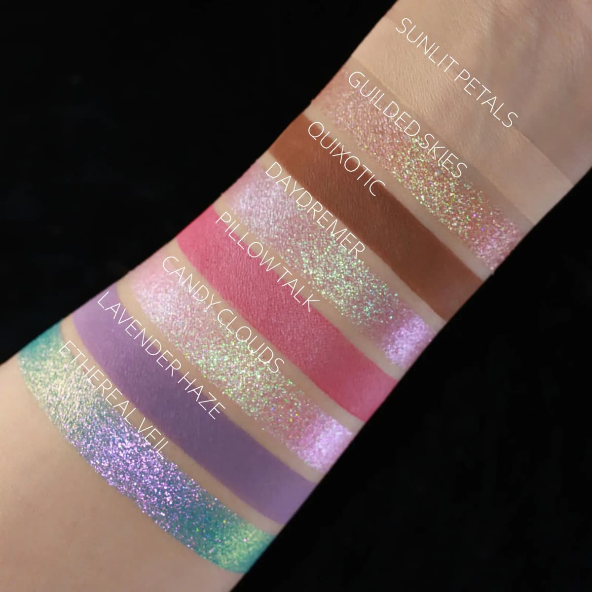 Arm swatches of eight shades labeled Sunlit Petals, Gilded Skies, Quixotic, Daydreamer, Pillow Talk, Candy Clouds