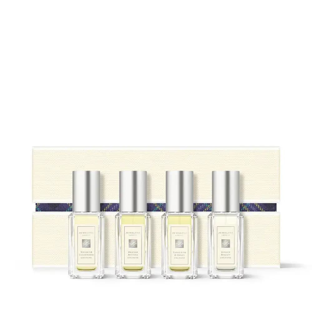 Four mini colognes, Whisky & Cedarwood, Orange Bitters, Tangerine & Honey and Ginger Biscuit, before a cream box