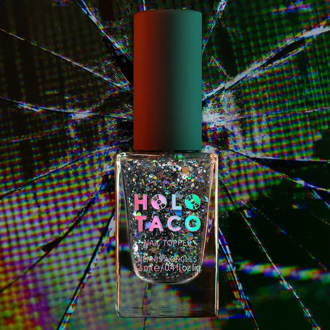 Nail topper bottle with black and holographic glitter pieces against a cracked glitchy screen backdrop