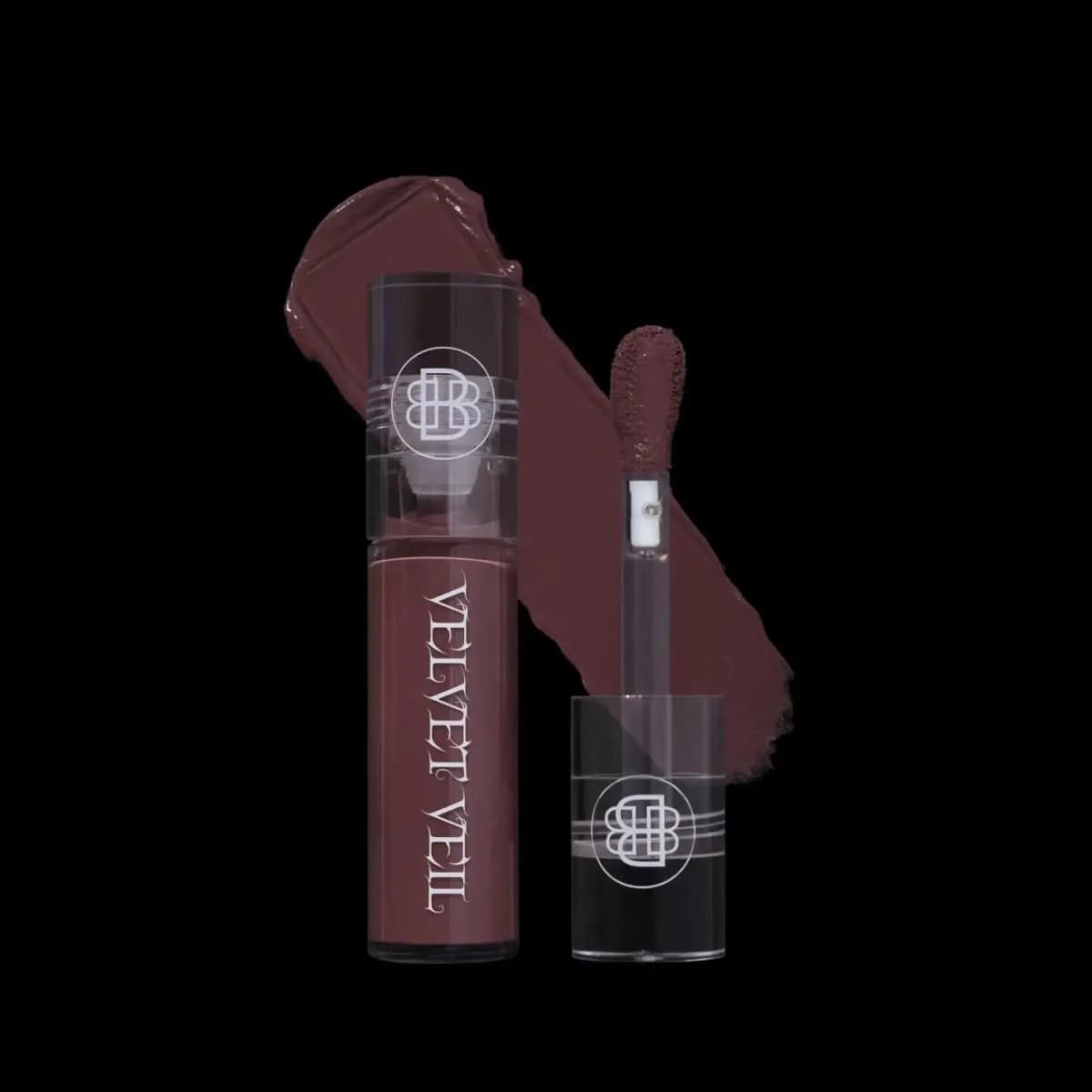 Plum-mauve brown lip mud tube beside its applicator and a velvety berry-brown swatch