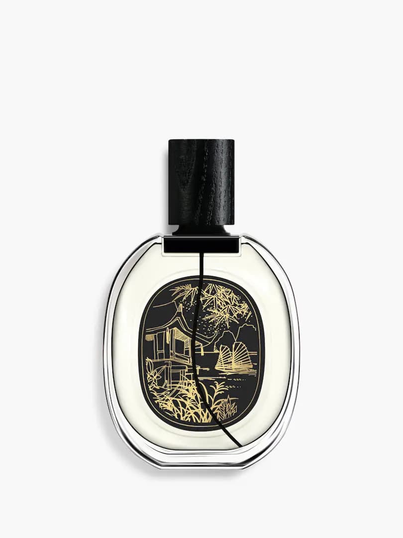 Back label of Do Son showing a gold-etched pavilion, bamboo and junk boat on black