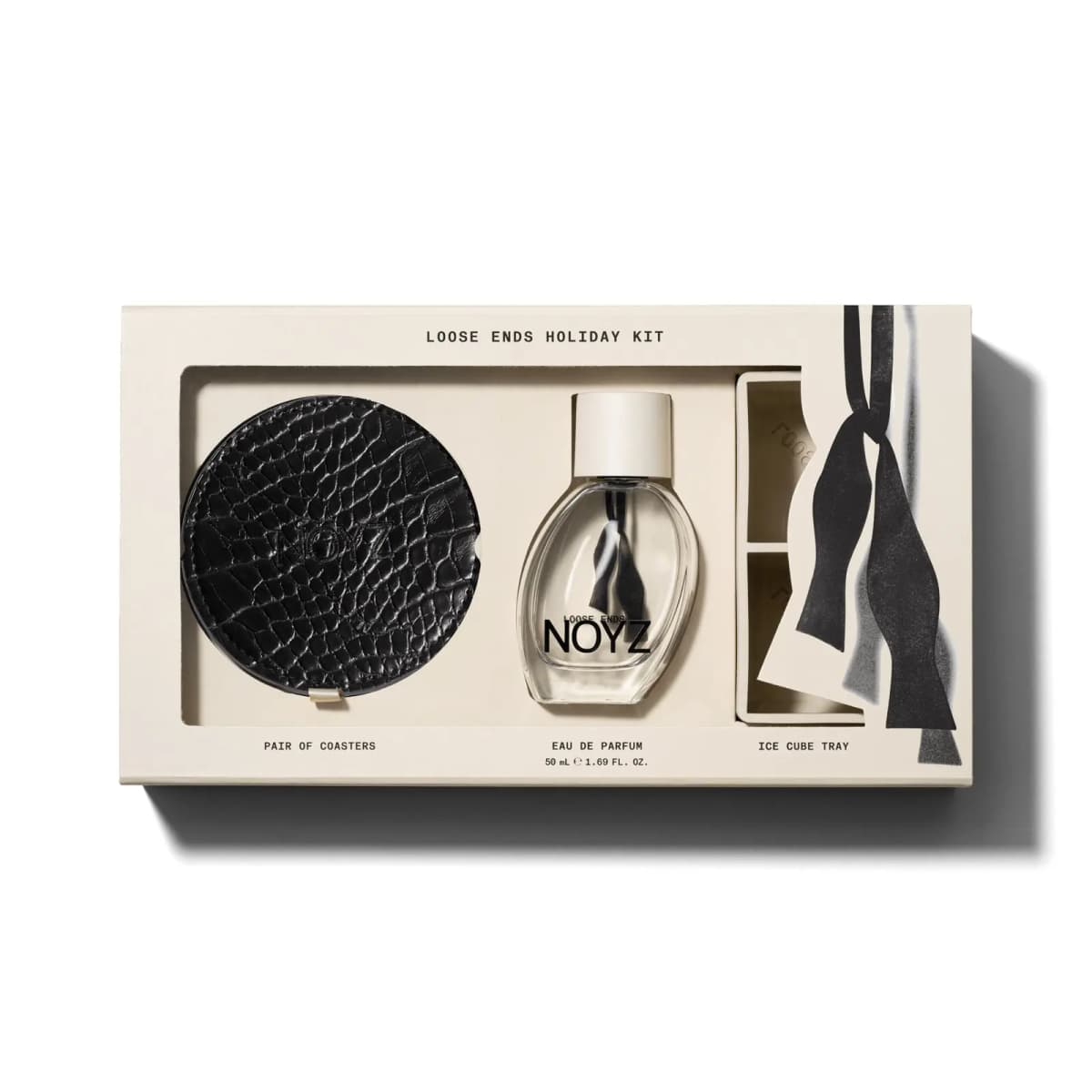 Loose Ends Holiday Kit box with black croc coasters, 50 mL Eau de Parfum and cream ice cube tray behind a bow-tie flap
