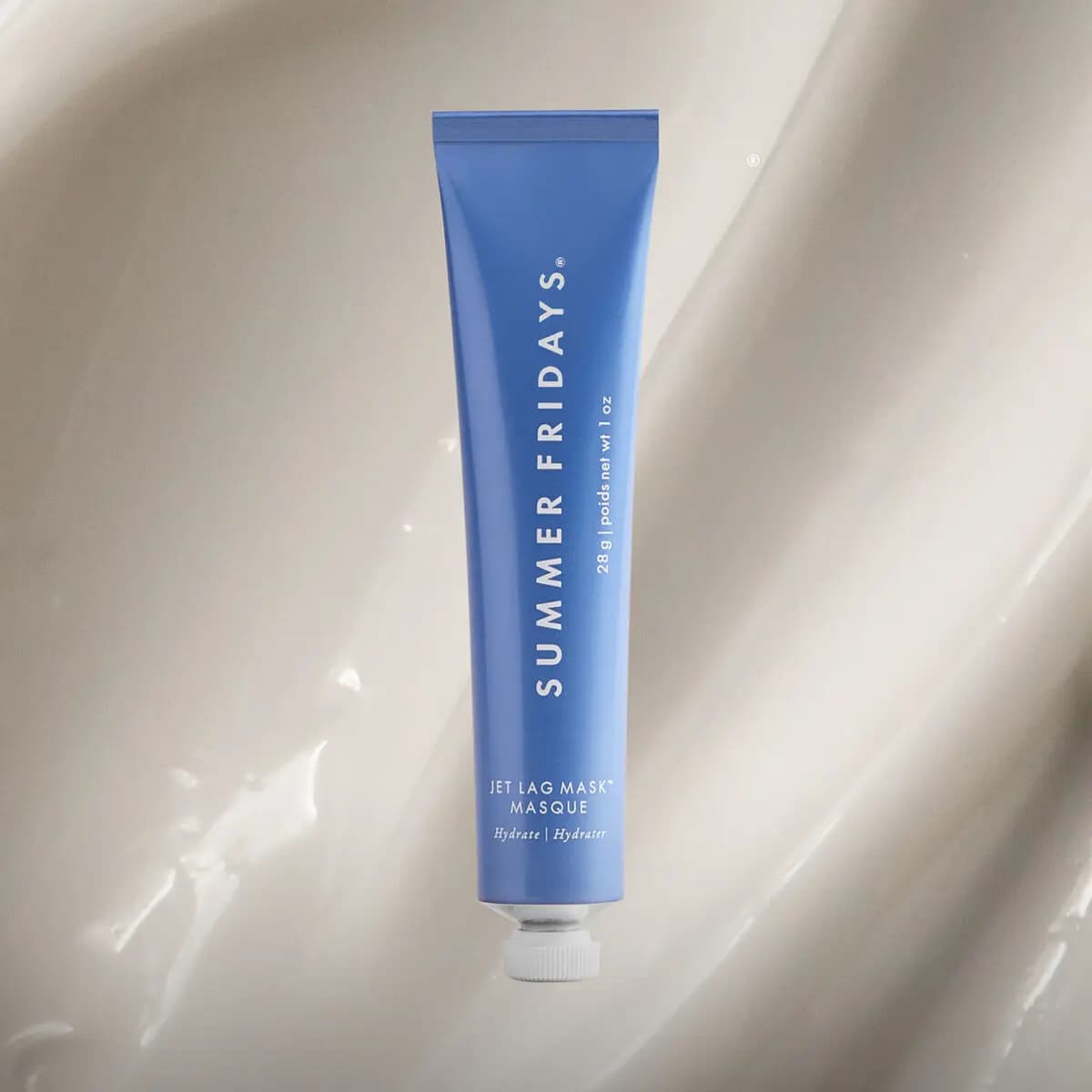Blue Summer Fridays Jet Lag Mask tube over a creamy white mask texture swirl