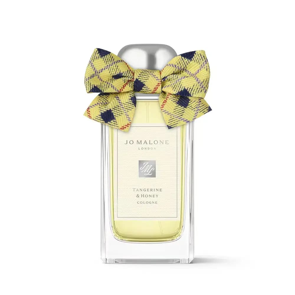 Tangerine & Honey Cologne bottle with a yellow and navy tartan bow, pale gold liquid, on white