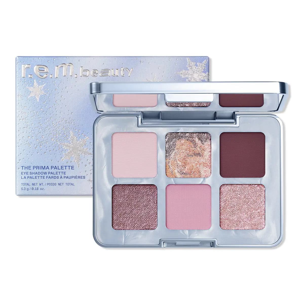 R.e.m. beauty Prima Palette open beside its blue snowflake-print box, showing six pink, mauve, plum and shimmer shades.