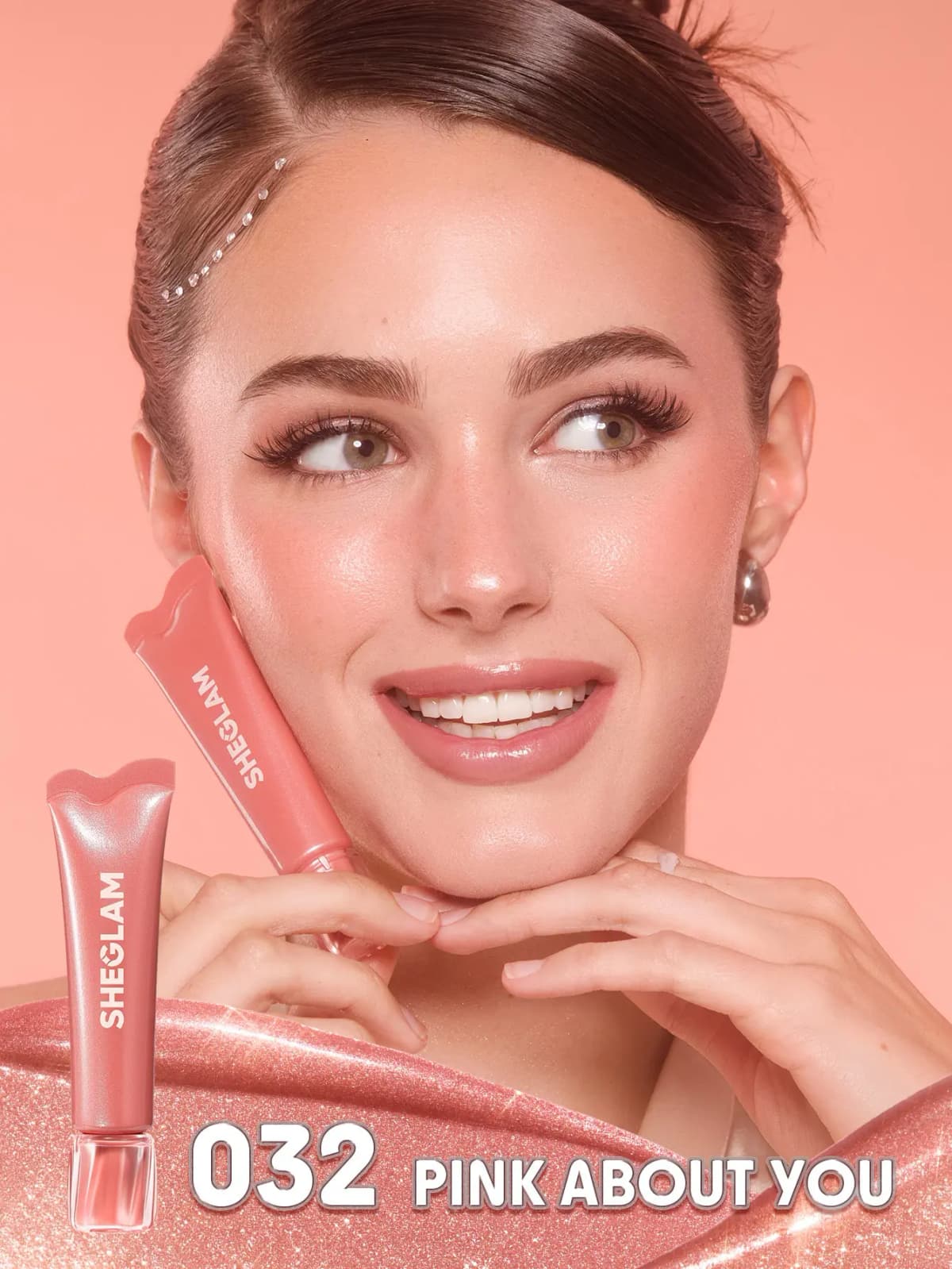 Smiling model with a peachy-pink shimmer flush holds a tube to the cheek, labelled 032 Pink About You