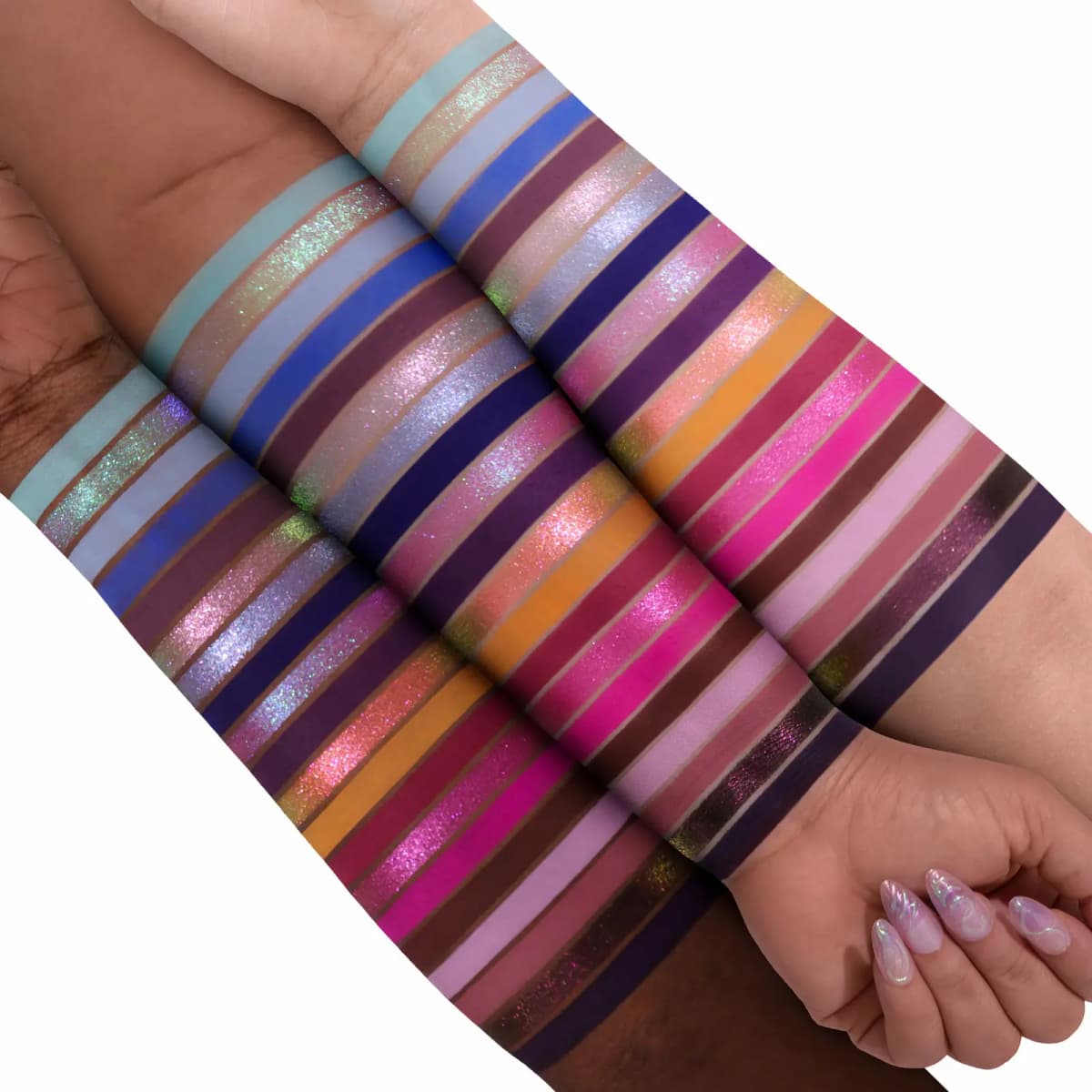 Two arms stacked showing diagonal swatches of 20 shadow shades across different skin tones