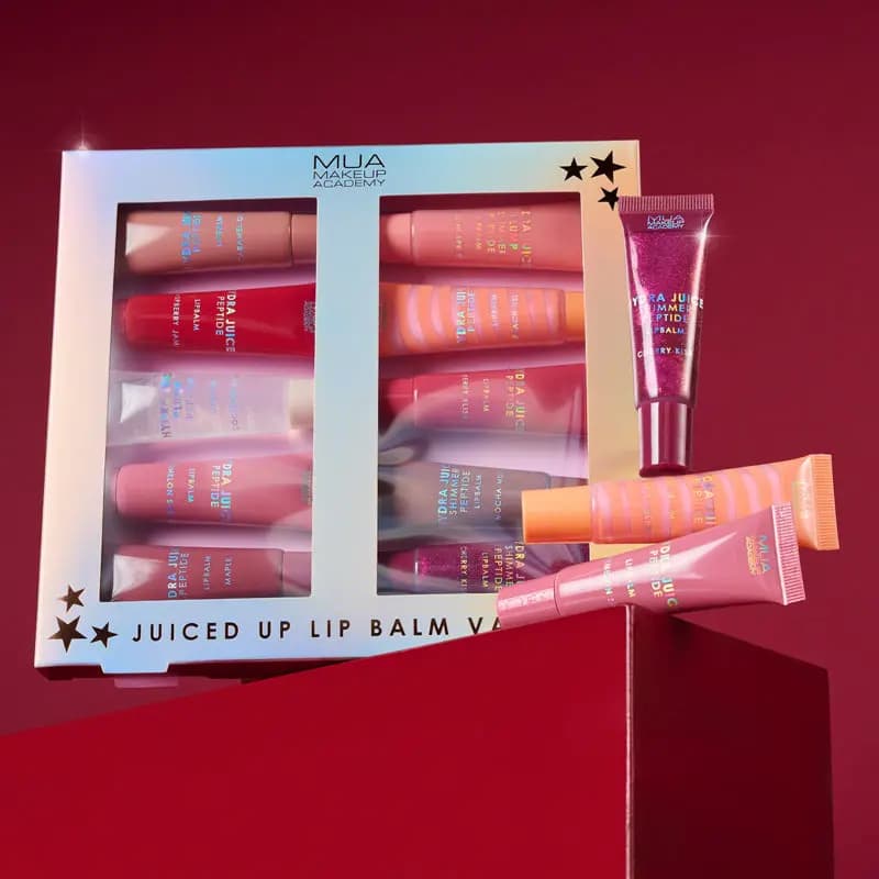 MUA Juiced Up Lip Balm box of Hydra Juice tubes, with sparkly berry Cherry Kiss, orange and pink tubes on a red block.