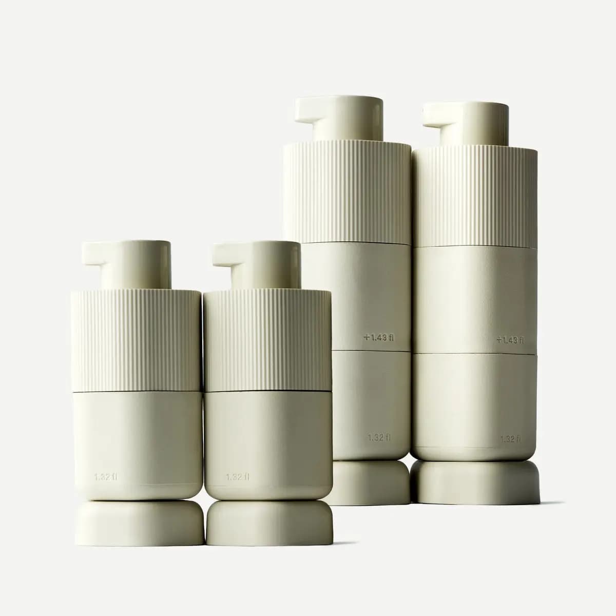 Two Medium and two Large cream Pump Capsules marked 1.32 fl and +1.43 fl, standing on bases