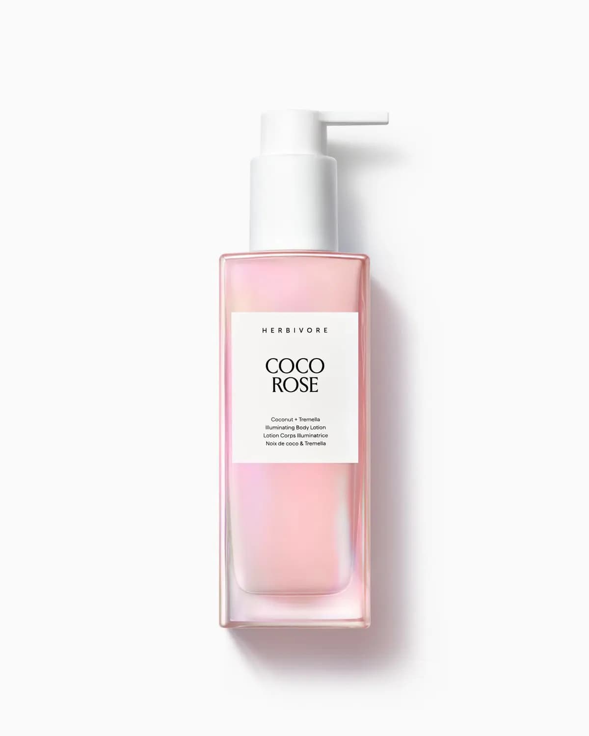 Herbivore COCO ROSE Illuminating Body Lotion in an iridescent pink square bottle with white pump on a white background