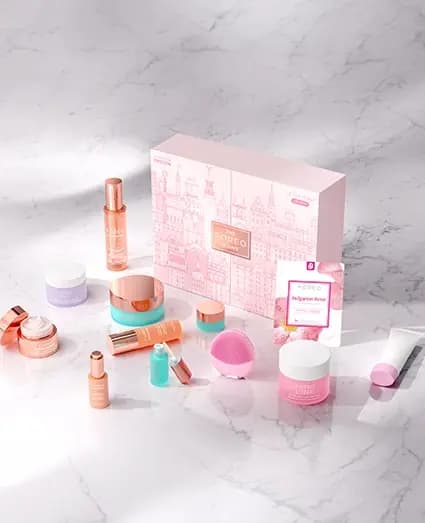 LUNA 4 mini Edition box on marble with pink LUNA 4 mini, Bulgarian Rose mask, KIWI jar and rose-gold skincare