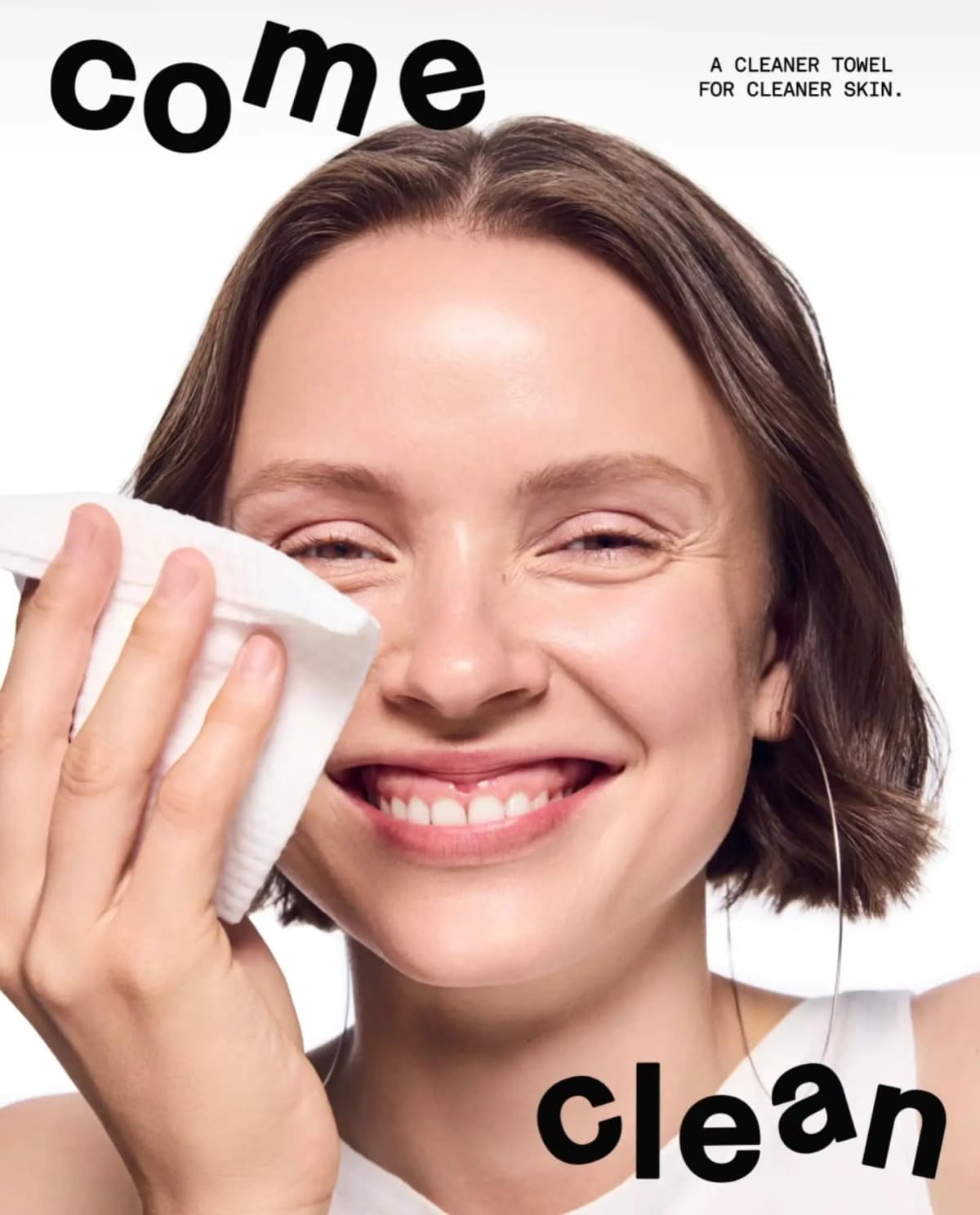 Smiling brunette woman with a bob wiping her eye with a white facial cloth beside bold 'come clean' text.