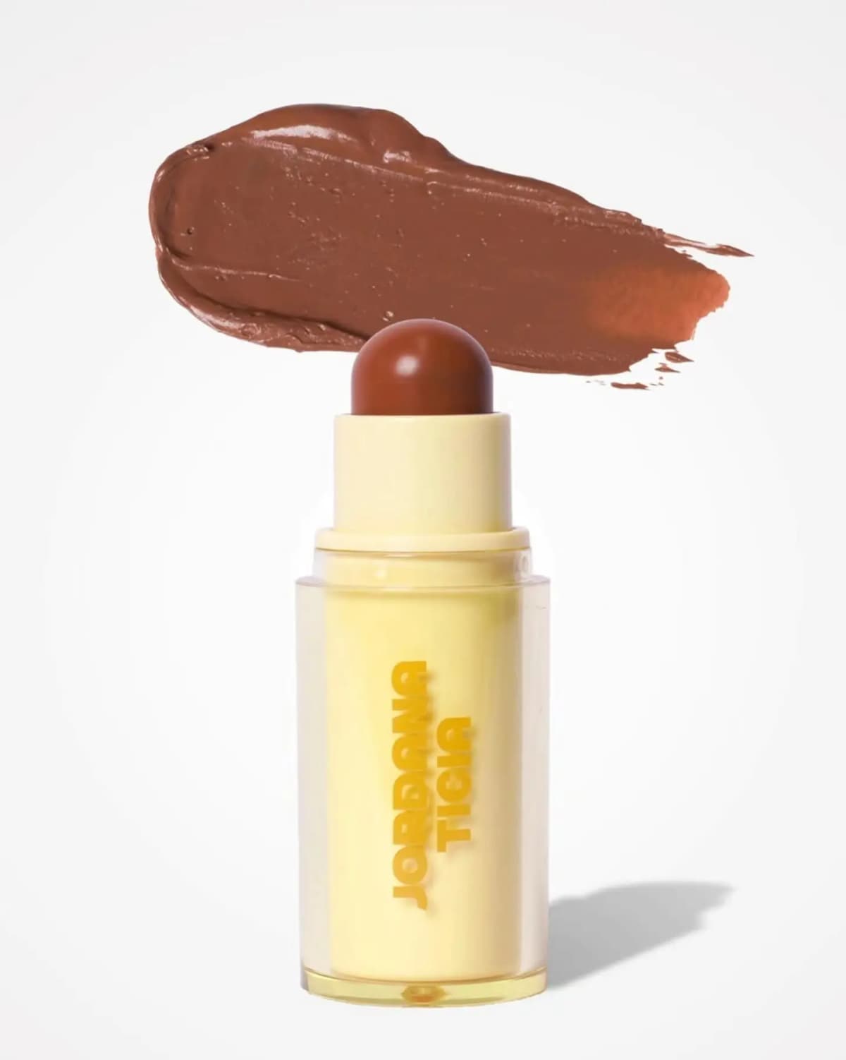 Single stick with a reddish-brown domed bullet beneath a glossy cream swatch of the same shade