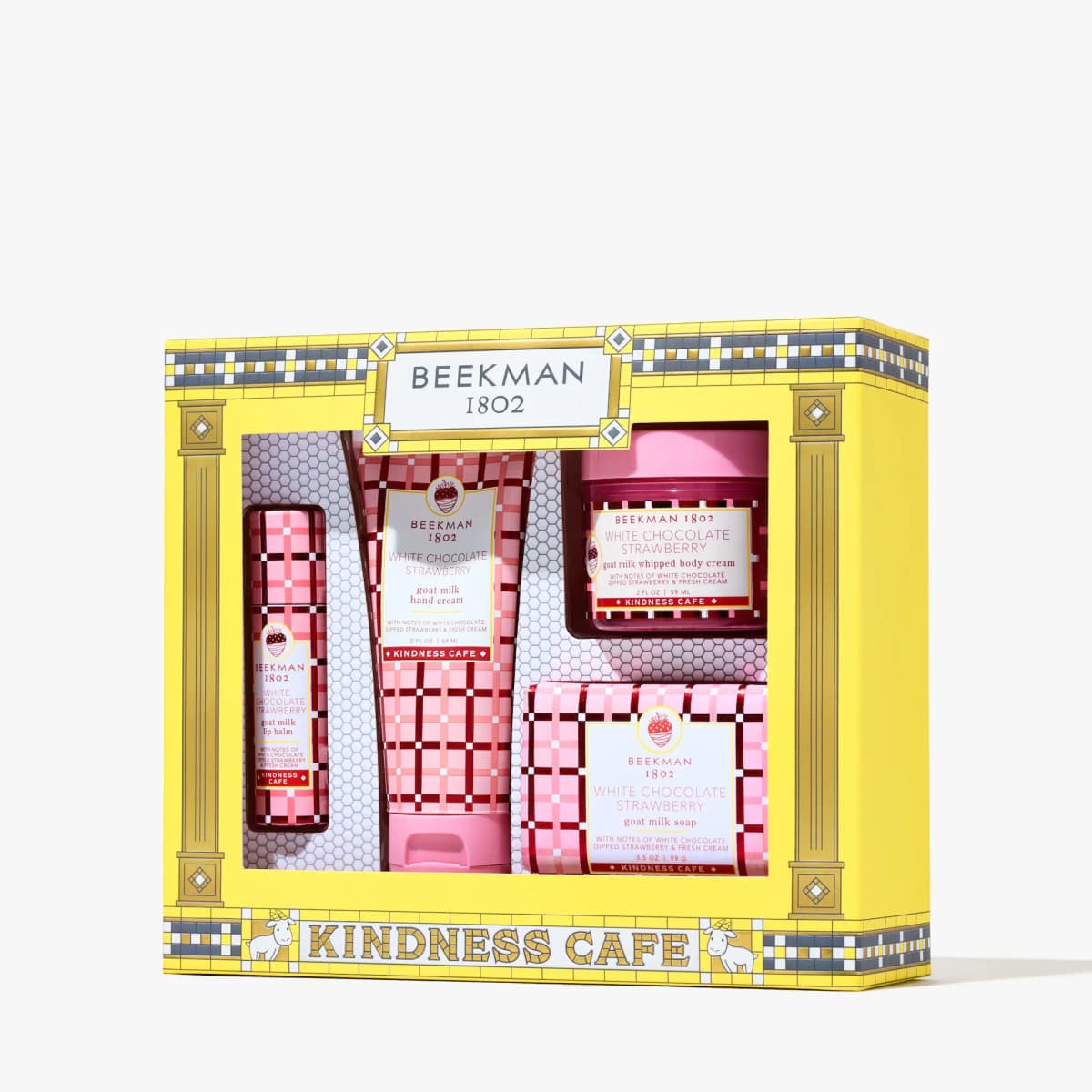 Beekman 1802 Kindness Café yellow gift box containing lip balm, hand cream, whipped body cream, and bar soap