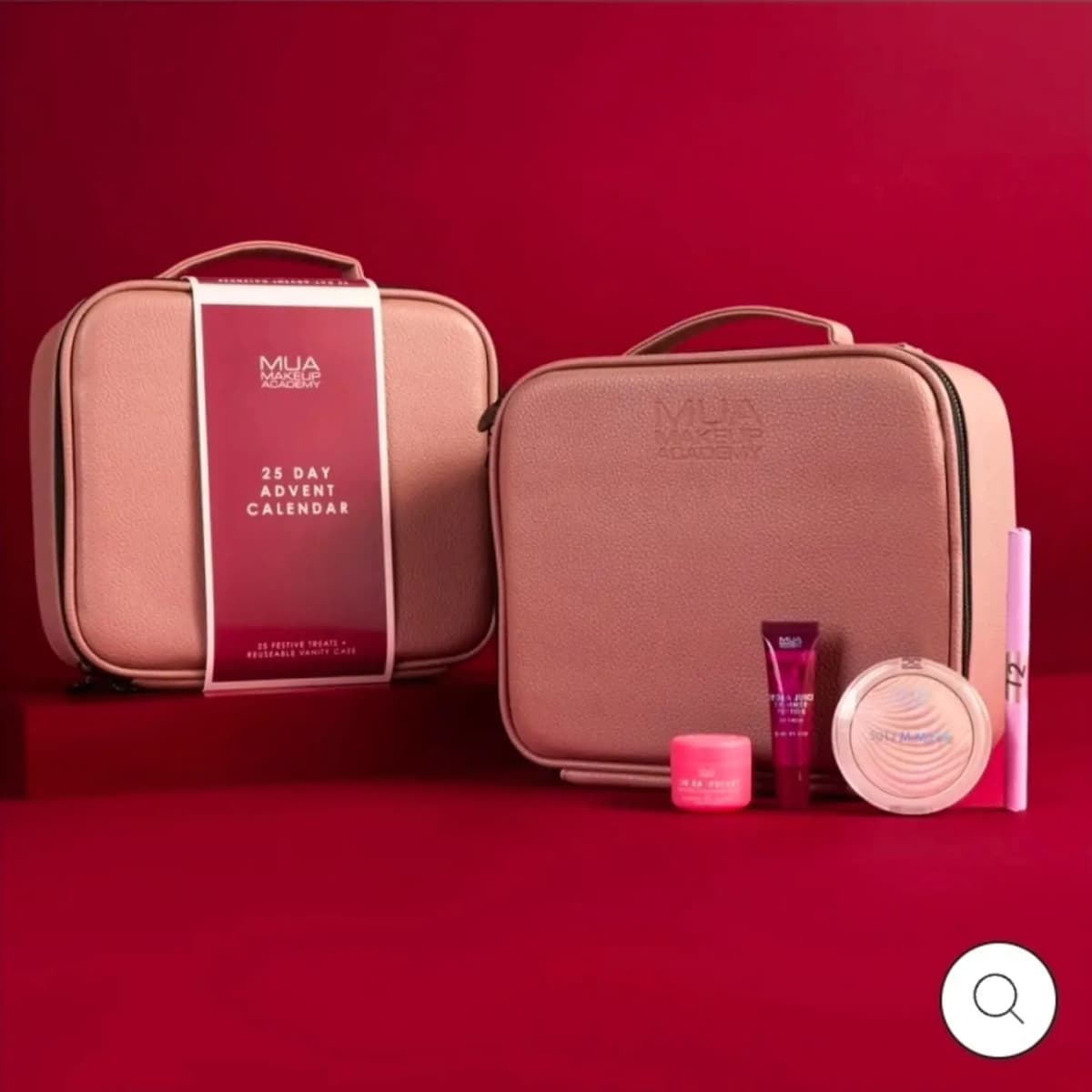 MUA 25 Day Advent Calendar in two pink vanity cases on red, with a lip balm, pink pot, highlighter and pen in front.