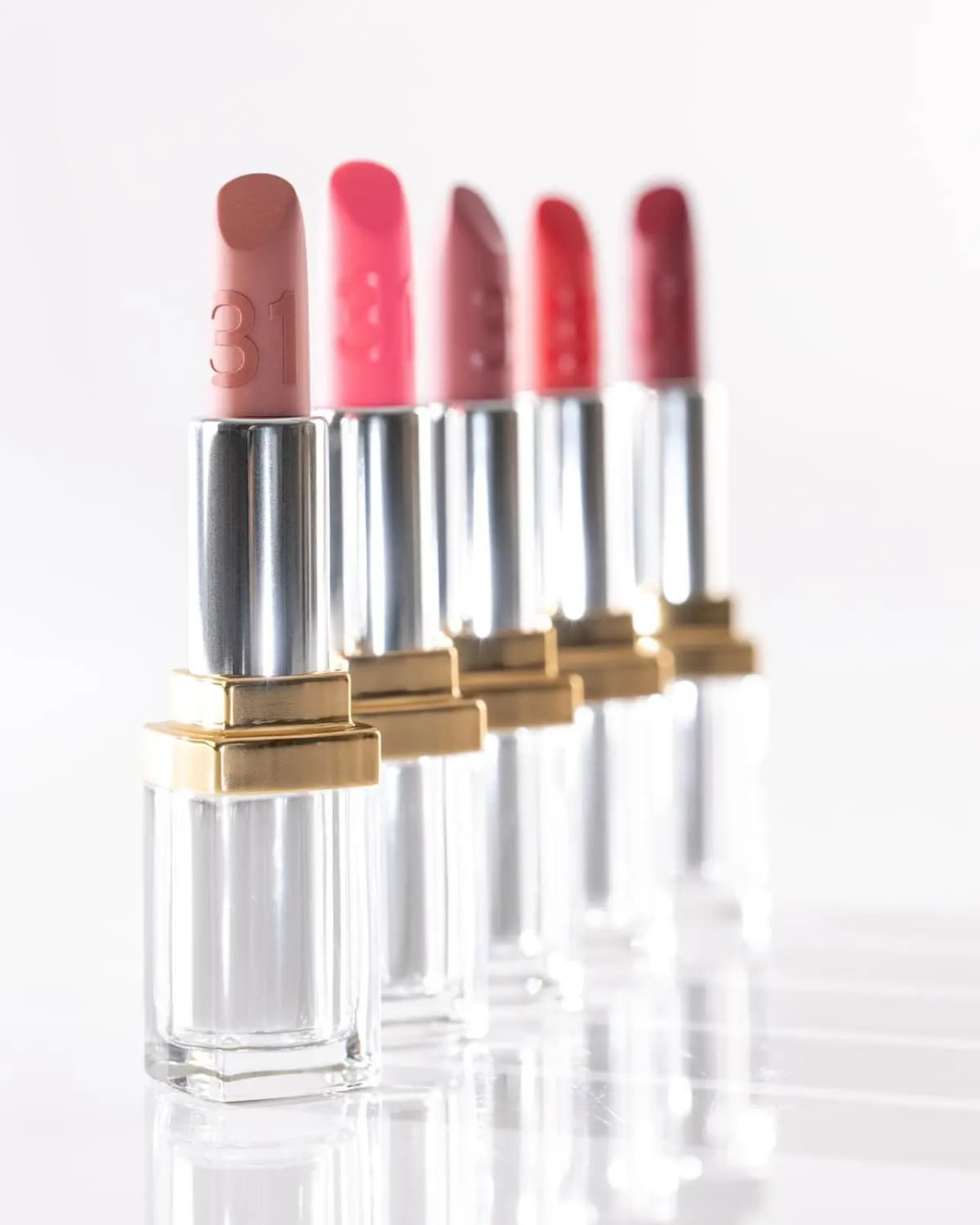 Chanel 31 Le Rouge Supreme Lip five lip balm shades in a row, from rose beige to garnet, each embossed with 31
