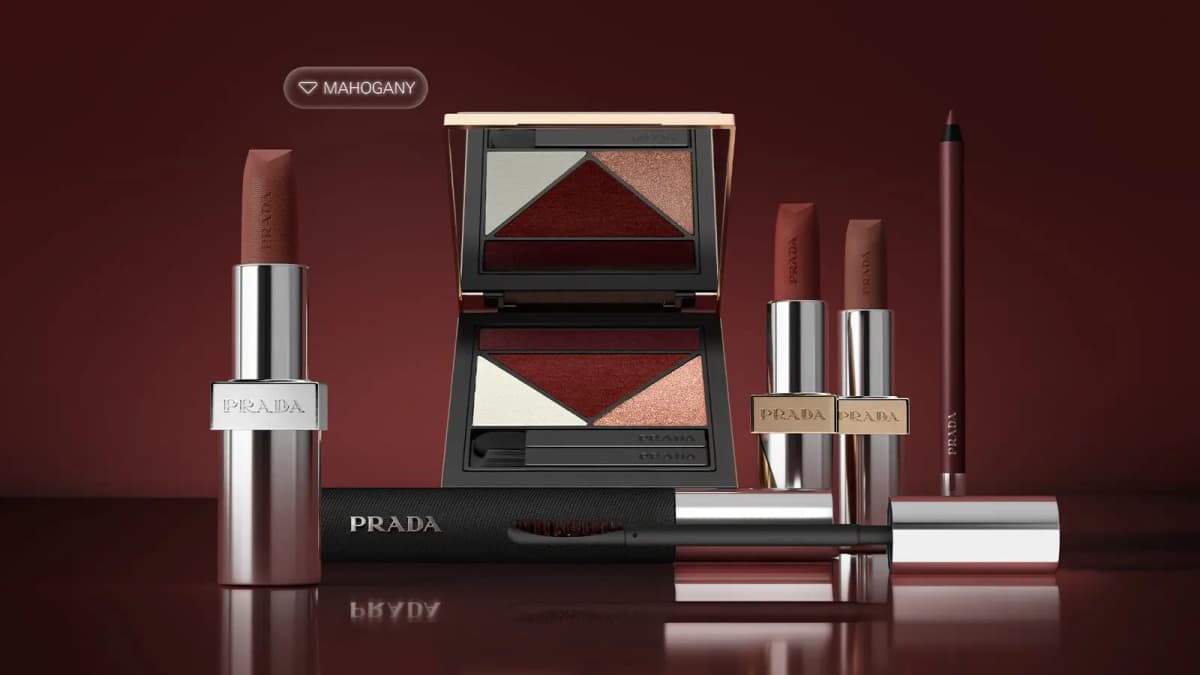 Prada Beauty Mahogany Collection with palette, three lipsticks, mascara and eye pencil on a dark red-brown background