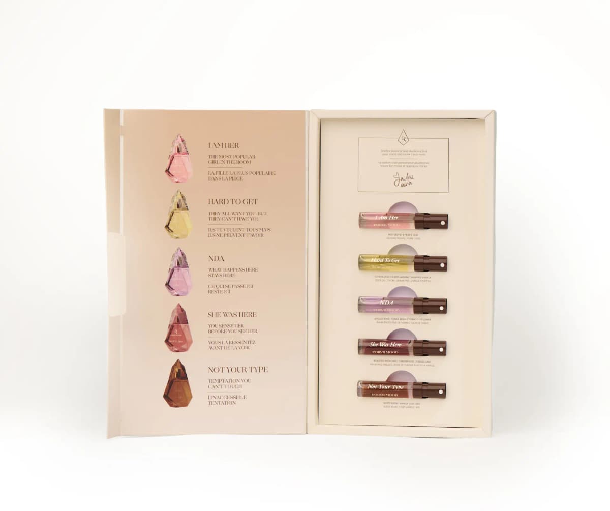 Open set with bottle illustrations and taglines on the left flap, five labelled vials with scent notes in the tray