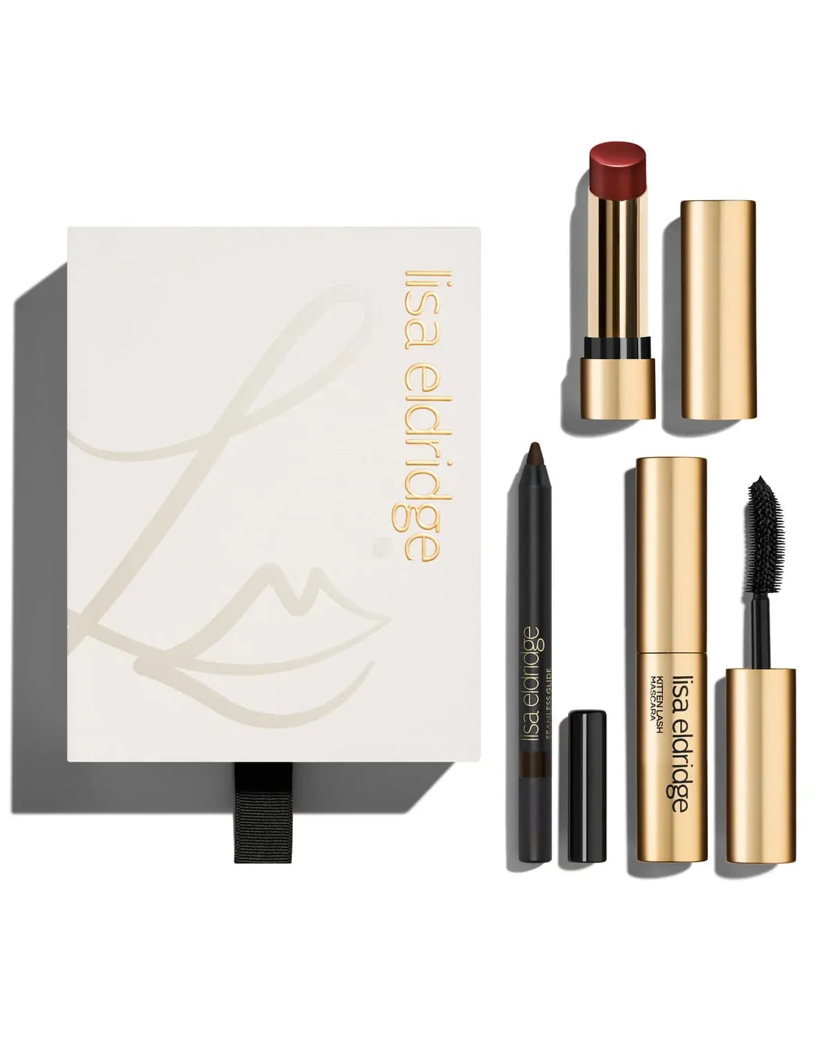 Ivory gift box with a deep red lipstick, dark brown eye pencil and gold Kitten Lash mascara with its wand