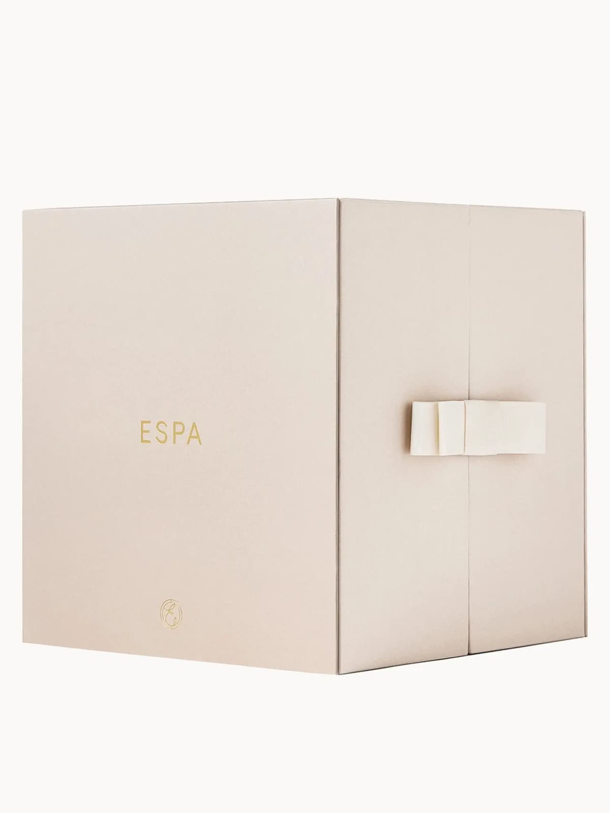 Closed cube-shaped beige gift box with gold ESPA logo and cream ribbon bow on the doors
