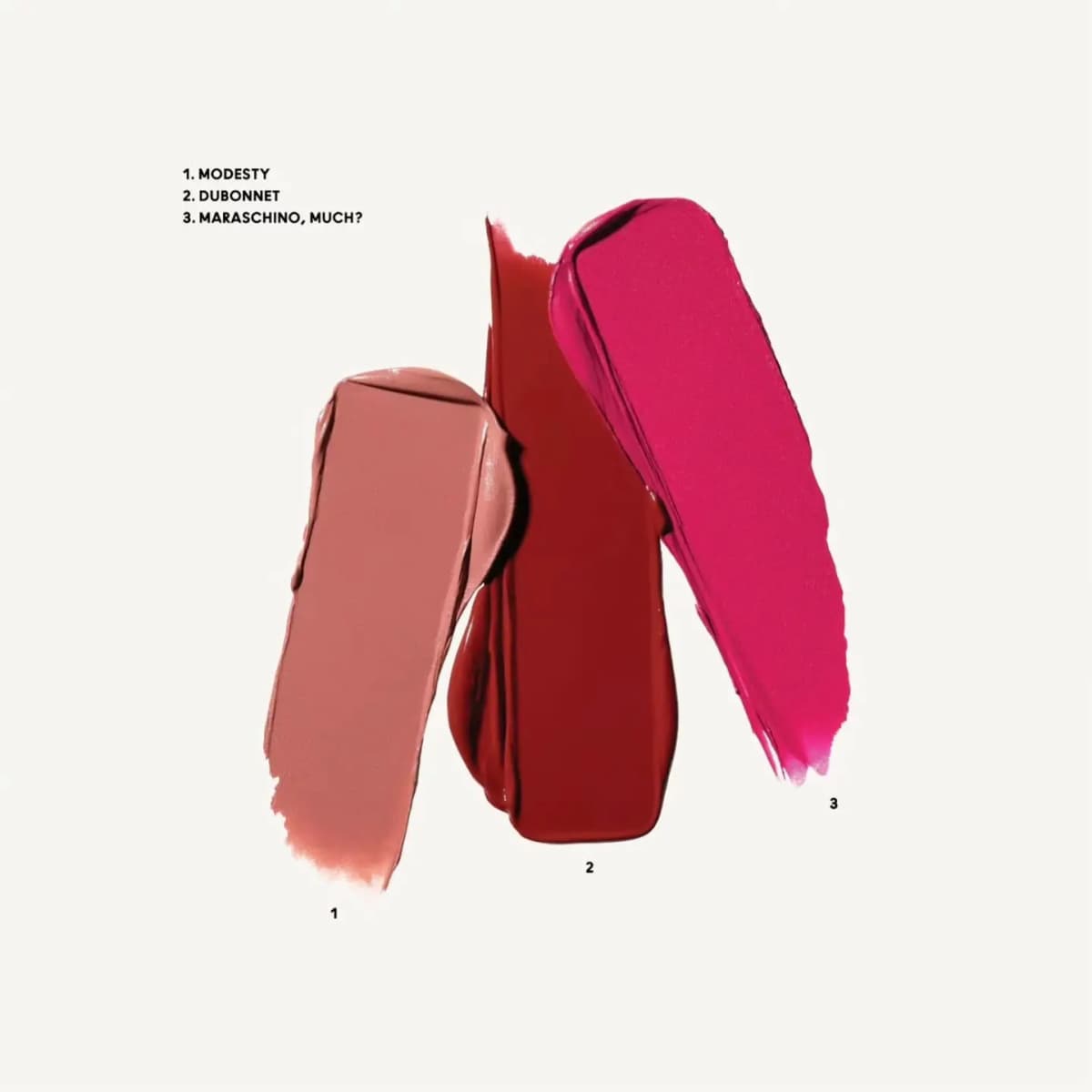 Labelled smear swatches of Modesty (muted pink), Dubonnet (wine) and Maraschino, Much? (blue red)