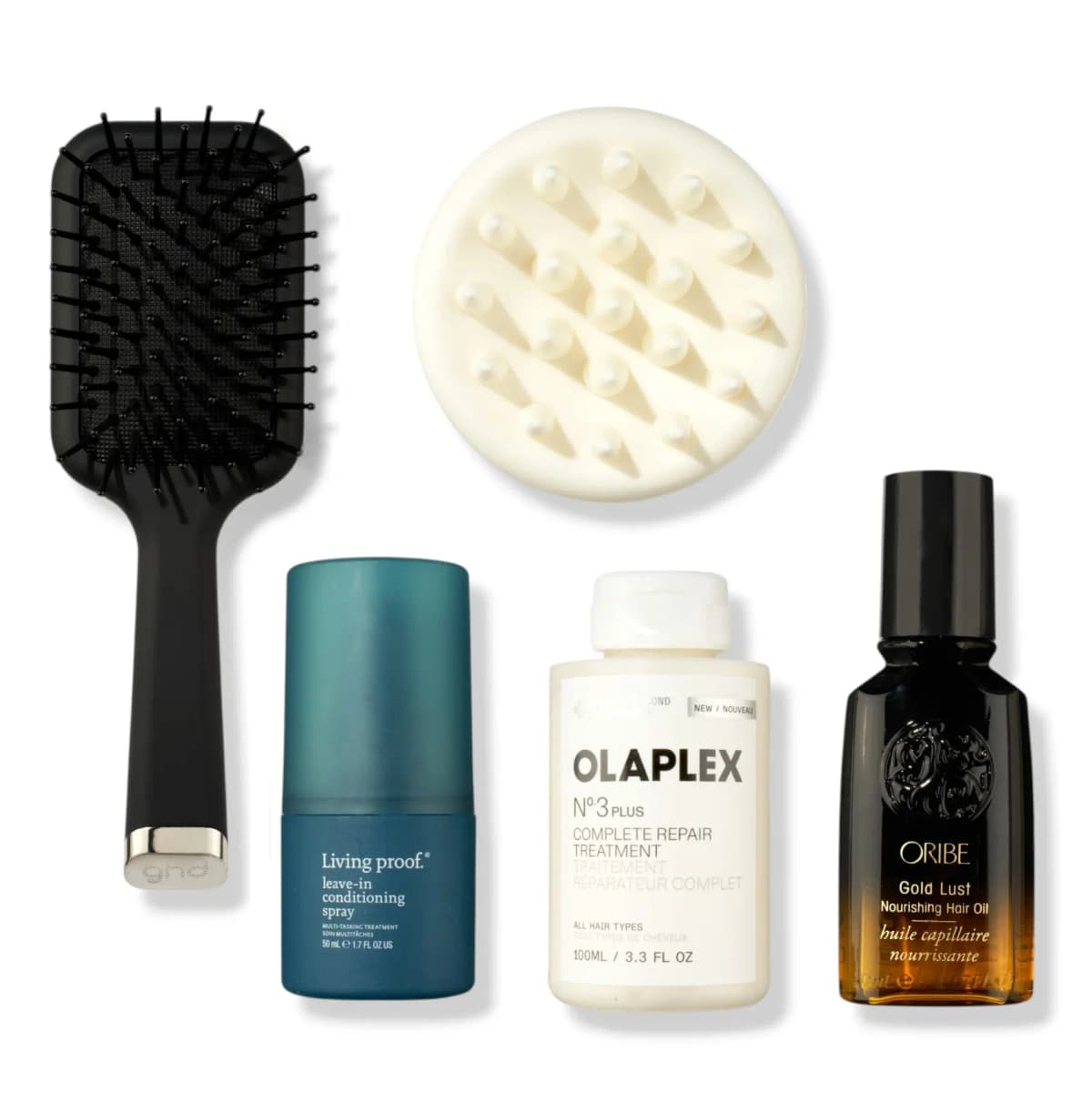 Black ghd paddle brush, cream scalp massager, Living Proof spray, Olaplex No.3 and Oribe Gold Lust oil on white