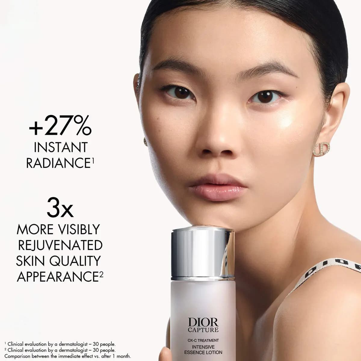 Model with sleek dark hair holds the lotion bottle to the chin beside +27% instant radiance and 3x rejuvenation claims.