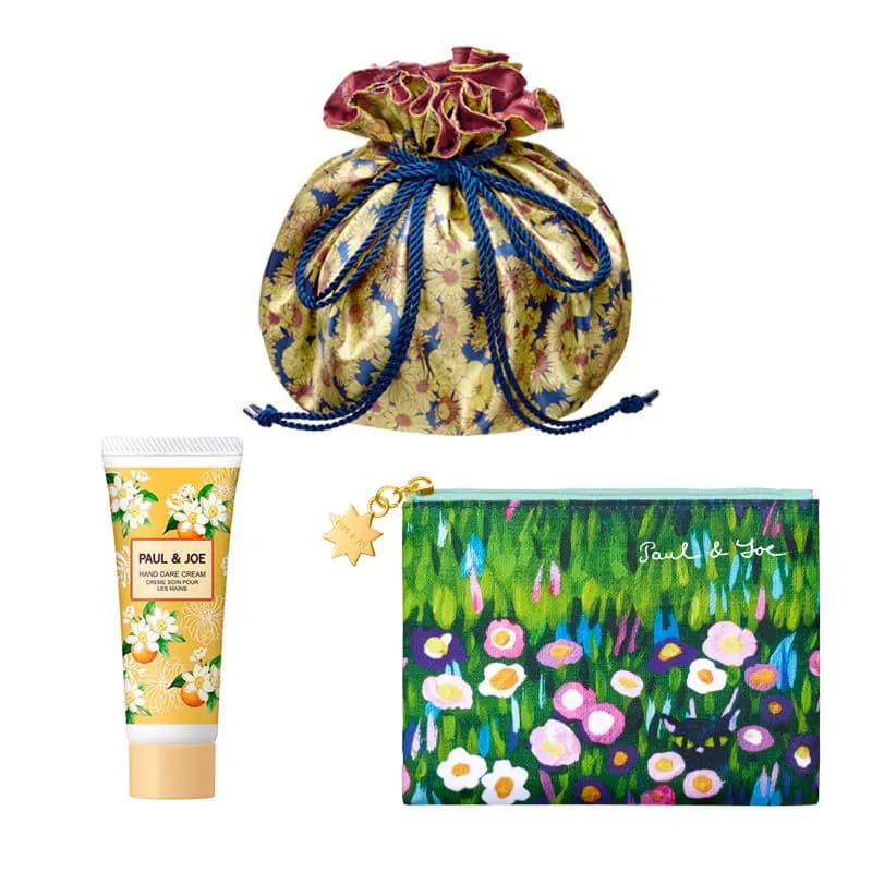 Gold floral drawstring pouch with navy cord, Paul & Joe Hand Care Cream tube and a green flower-print zip pouch