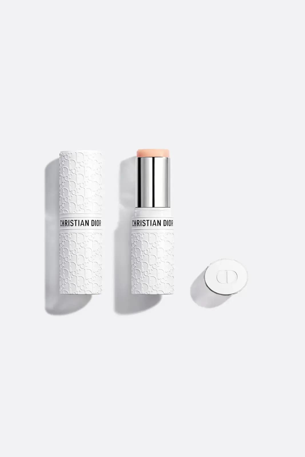 Dior Mattifying Invisible UV Stick SPF 50 in white Dior Oblique-embossed case, shown capped, uncapped and with lid