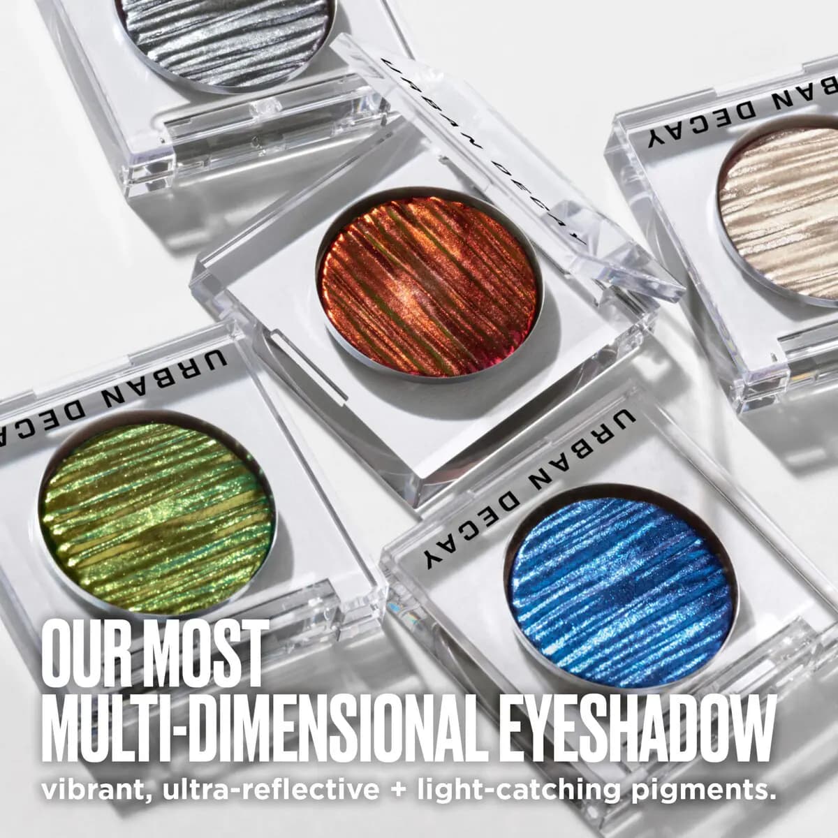 Five open clear compacts of silver, red, champagne, green and blue chrome shadows; text: "Our most multi-dimensional