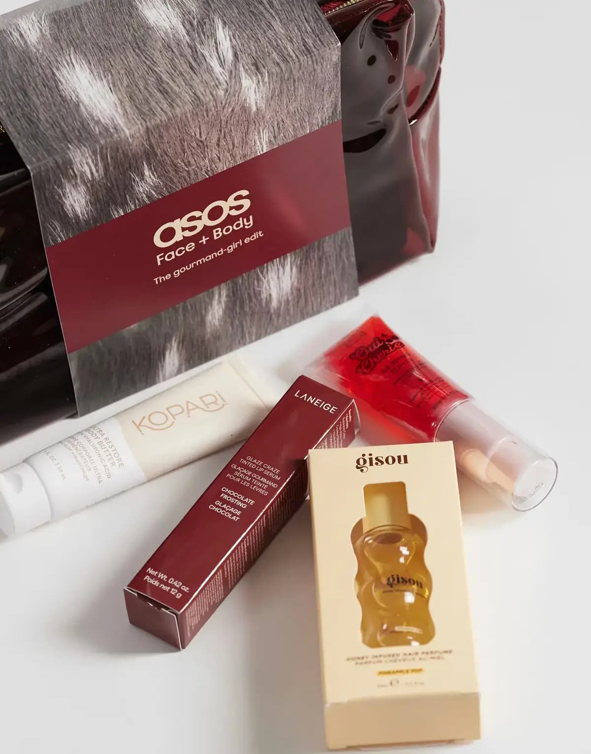 Laneige Chocolate Frosting lip serum box and Gisou hair perfume box with Kopari tube and red gloss by Gourmand-Girl sleeve