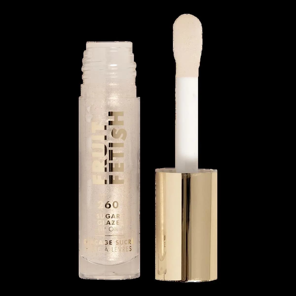 Open 260 Sugar Glaze tube of clear shimmer oil beside its gold cap and pale doe-foot applicator